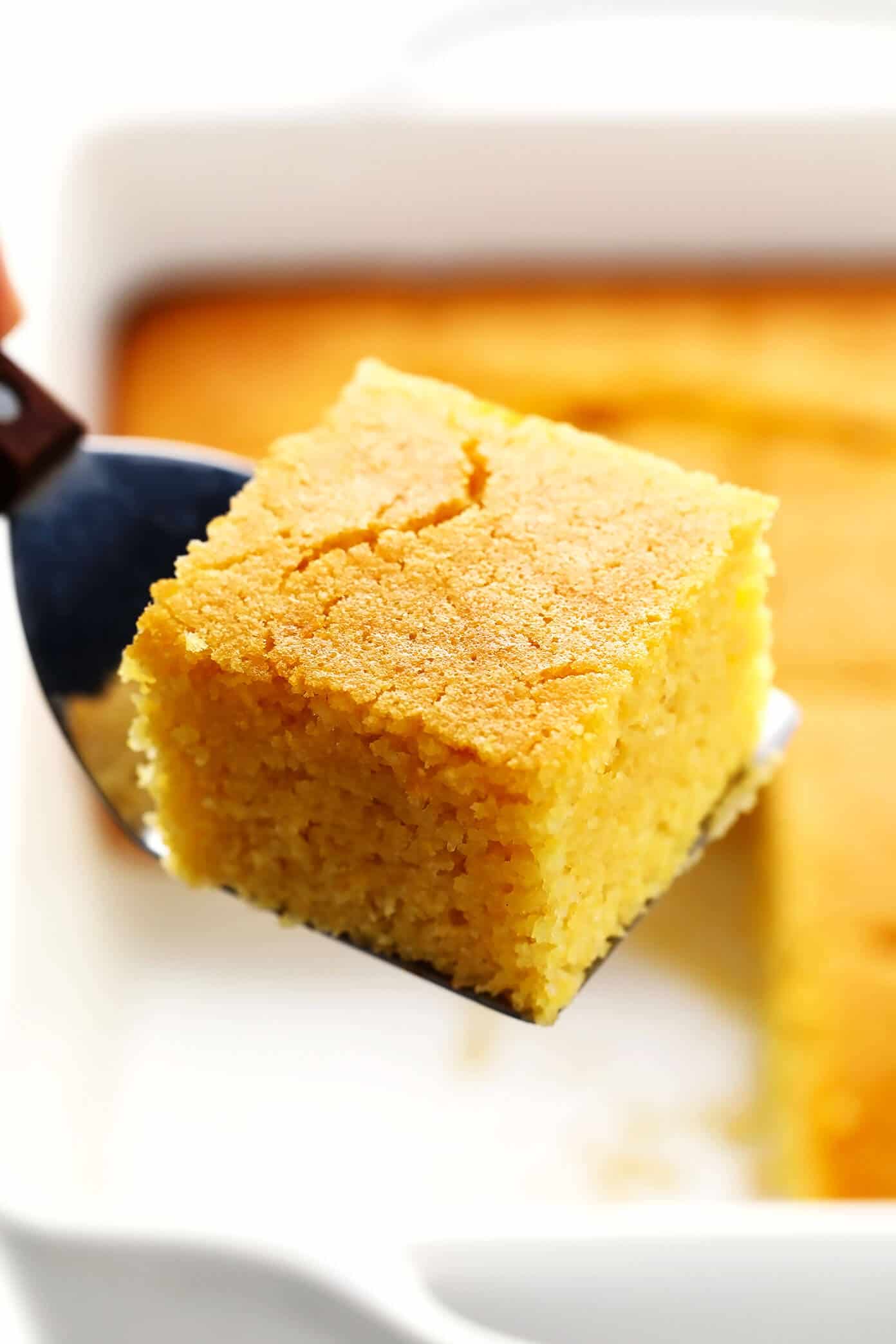 This amazing homemade cornbread recipe is lightly sweetened with honey, made extra moist with buttermilk, and tastes so buttery and delicious! Easy to make in a basic baking dish or cast iron skillet, or you can use this batter to make cornbread muffins. And perfect for serving with soup, chili, dressing/stuffing, or whatever sounds good! | gimmesomeoven.com #cornbread #bread #healthy #skillet #side #homemade #vegetarian #glutenfree Homemade Cornbread Square in Baking Pan