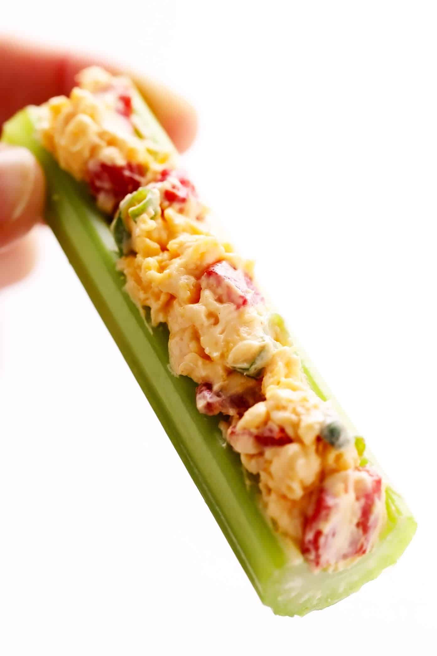 This 10-minute homemade pimento cheese recipe is made with sharp cheddar, tangy cream cheese and mayo, roasted red peppers, fresh green onions, and a zesty blend of seasonings. Serve it as a appetizer dip or spread on sandwiches, burgers, veggies, or whatever sounds good. | gimmesomeoven.com #pimento #pepper #cheese #dip #spread #glutenfree #southern #sandwich Celery Stick with Pimento Cheese