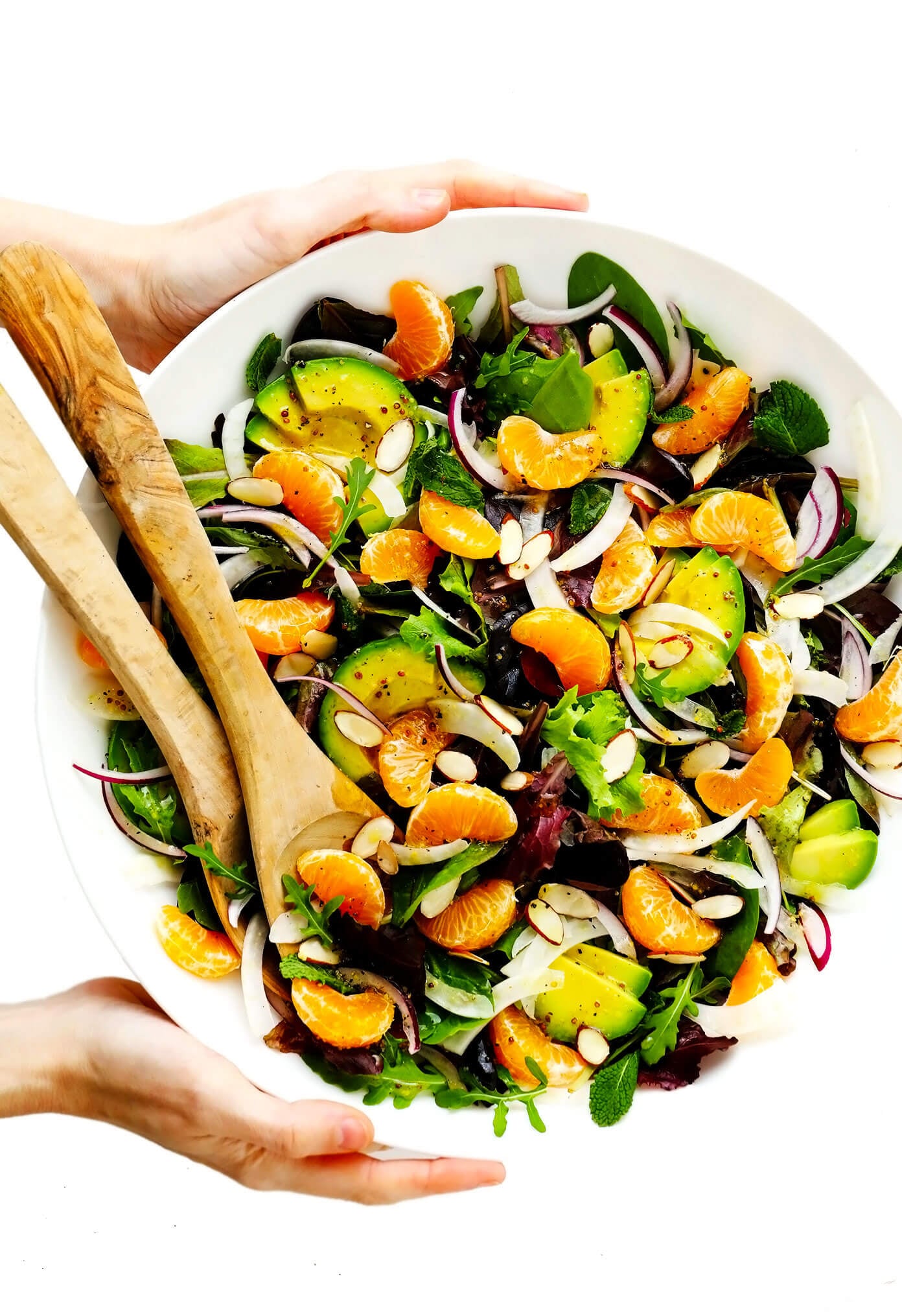 This Orange, Fennel and Avocado Salad recipe is quick and easy to make with fresh spring greens and mint, fresh clementines, toasted almonds, and a quick honey-citrus dressing. It's naturally vegan, vegetarian and gluten-free, but feel free to add in an extra protein (such as salmon, chicken or shrimp) if you'd like! | gimmesomeoven.com #salad #orange #citrus #avocado #healthy #glutenfree #vegan #vegetarian #dinner #winter Orange, Fennel and Avocado Salad