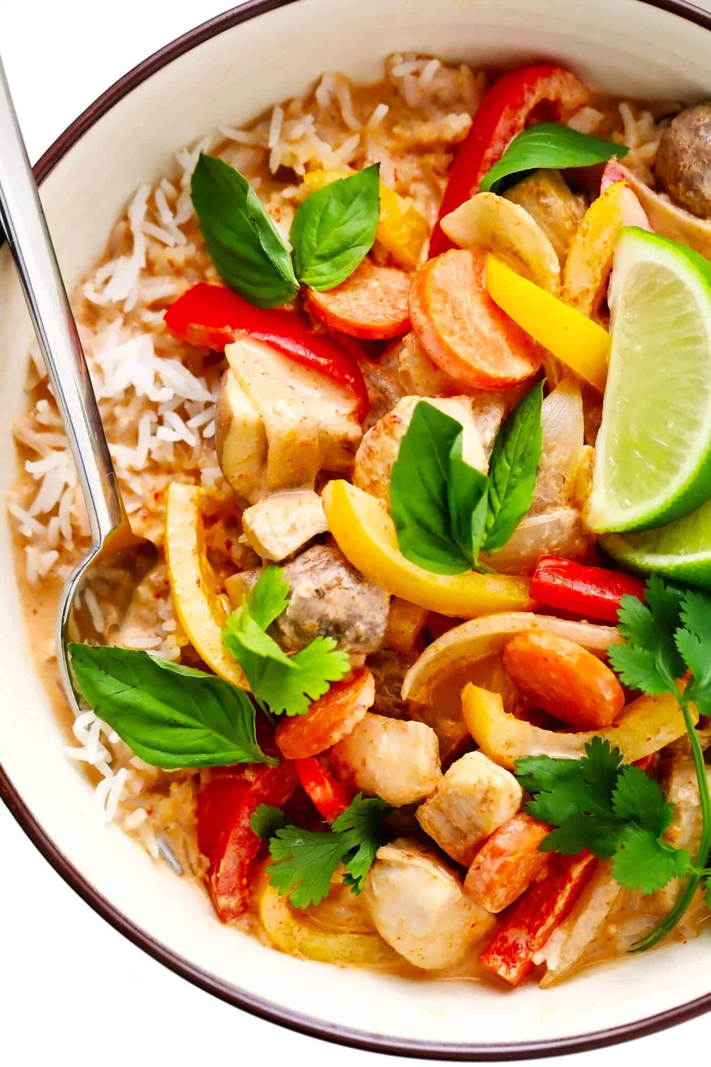 This cozy Thai Chicken Curry recipe is quick and easy to whip up in about 30 minutes, it's made with the yummiest Thai red coconut curry sauce, and it's easy to customize with your favorite veggies and proteins. Feel free to swap beef, pork, shrimp, tofu or vegetarian/vegan alternatives for the chicken and serve over rice, noodles, quinoa or on its own. | gimmesomeoven.com #thai #chicken #curry #stirfry #soup #asian #healthy #glutenfree #dinner #vegetable Thai Chicken Curry with Rice Closeup