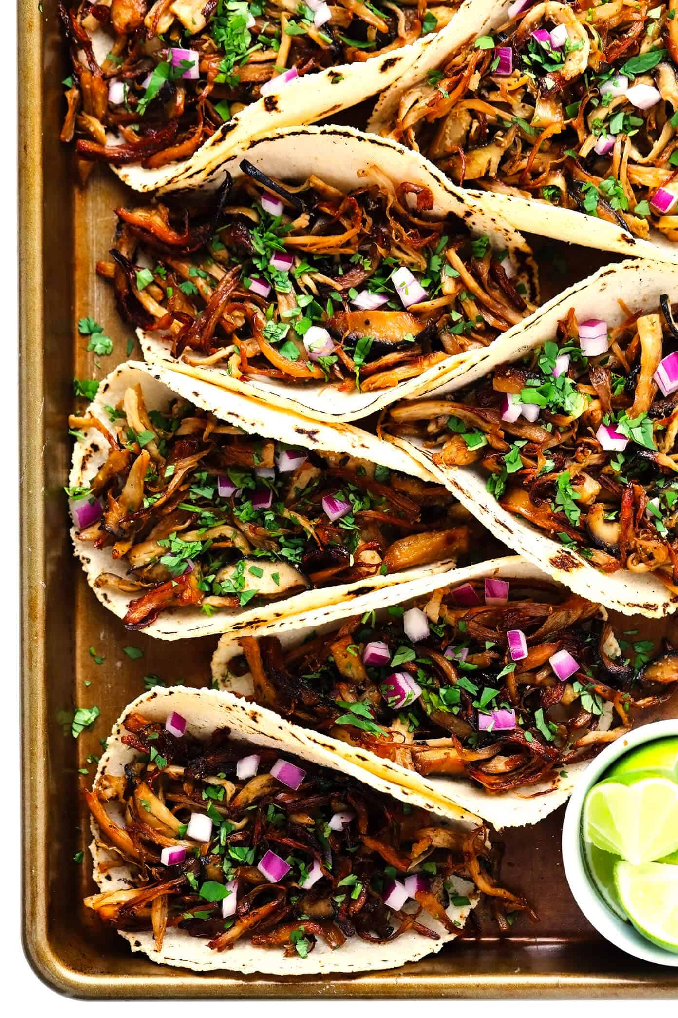 This Mexican mushroom "carnitas" recipe is fun and easy make with marinated shredded mushrooms that are roasted to crispy, juicy, delicious perfection! Vegetarian, vegan, gluten-free, and perfect for tacos, burritos, quesadillas and more. | gimmesomeoven.com #mushroom #carnitas #roasted #vegetarian #vegan #glutenfree #healthy #dinner #tacos Mushroom "Carnitas" Tacos with Limes