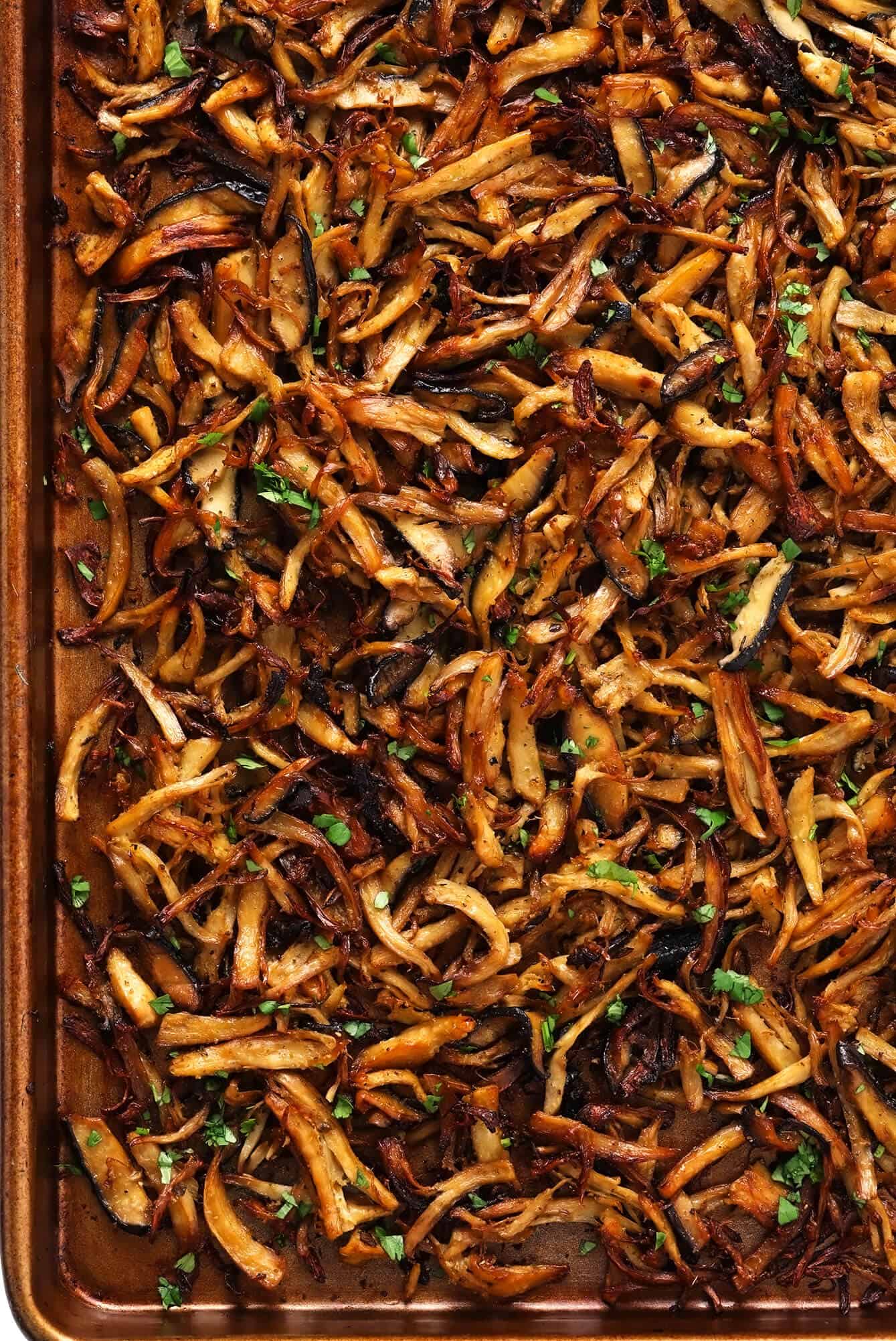This Mexican mushroom "carnitas" recipe is fun and easy make with marinated shredded mushrooms that are roasted to crispy, juicy, delicious perfection! Vegetarian, vegan, gluten-free, and perfect for tacos, burritos, quesadillas and more. | gimmesomeoven.com #mushroom #carnitas #roasted #vegetarian #vegan #glutenfree #healthy #dinner #tacos Mushroom Carnitas on Sheet Pan