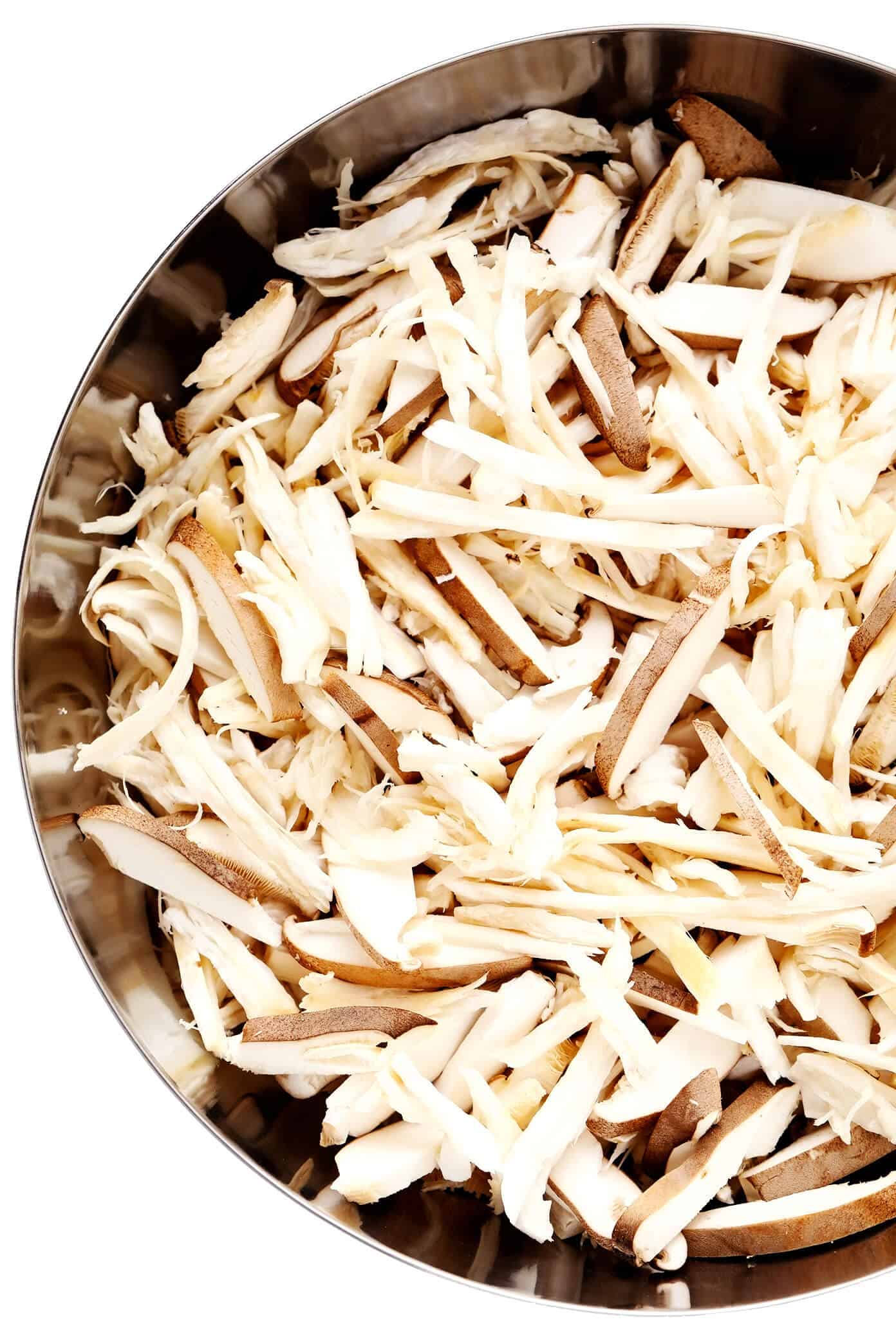 This Mexican mushroom "carnitas" recipe is fun and easy make with marinated shredded mushrooms that are roasted to crispy, juicy, delicious perfection! Vegetarian, vegan, gluten-free, and perfect for tacos, burritos, quesadillas and more. | gimmesomeoven.com #mushroom #carnitas #roasted #vegetarian #vegan #glutenfree #healthy #dinner #tacos Bowl of Shredded King Oyster Mushrooms
