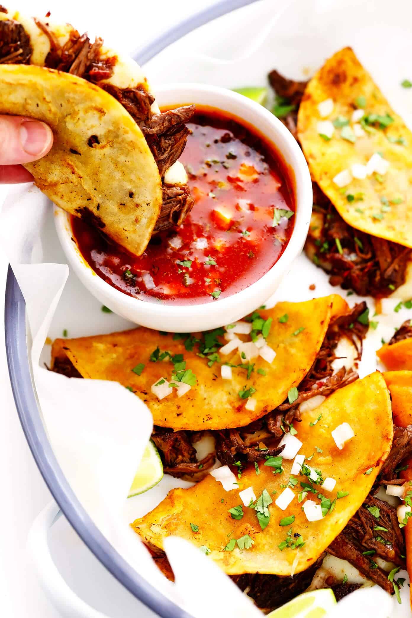 This delicious birria recipe (Mexican beef stew) is SO flavorful and comforting, and it's easy to make in Crock-Pot, Instant Pot or on the stovetop. Serve it as a simple stew or use this recipe to make birria tacos (or fried cheesy birria quesatacos) dipped in consomme! | gimmesomeoven.com #birria #stew #tacos #beef #crockpot #slowcooker #instantpot #pressurecooker #dinner #mexican Birria Tacos (Quesatacos) with Consomme