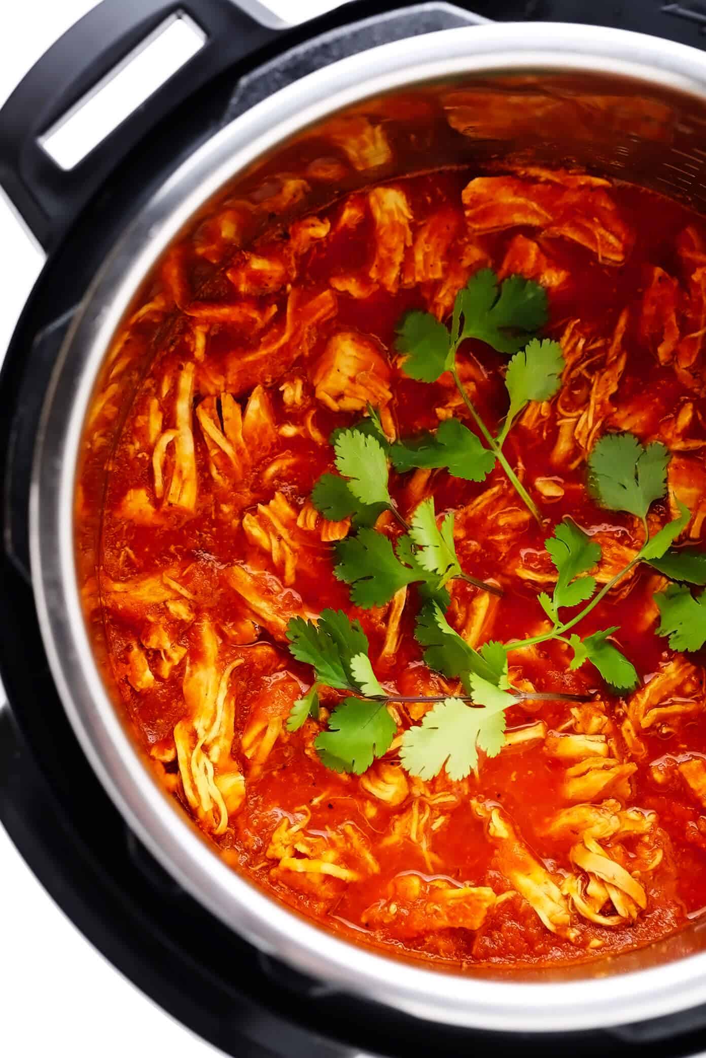 This Mexican Chicken Tinga recipe is remarkably quick and easy to make in 30 minutes and tossed with the best smoky, savory, and slightly-sweet tomato sauce. It's naturally gluten-free and perfect for serving for dinner in tacos, tostadas, burritos, quesadillas and more! | gimmesomeoven.com Instant Pot Chicken Tinga