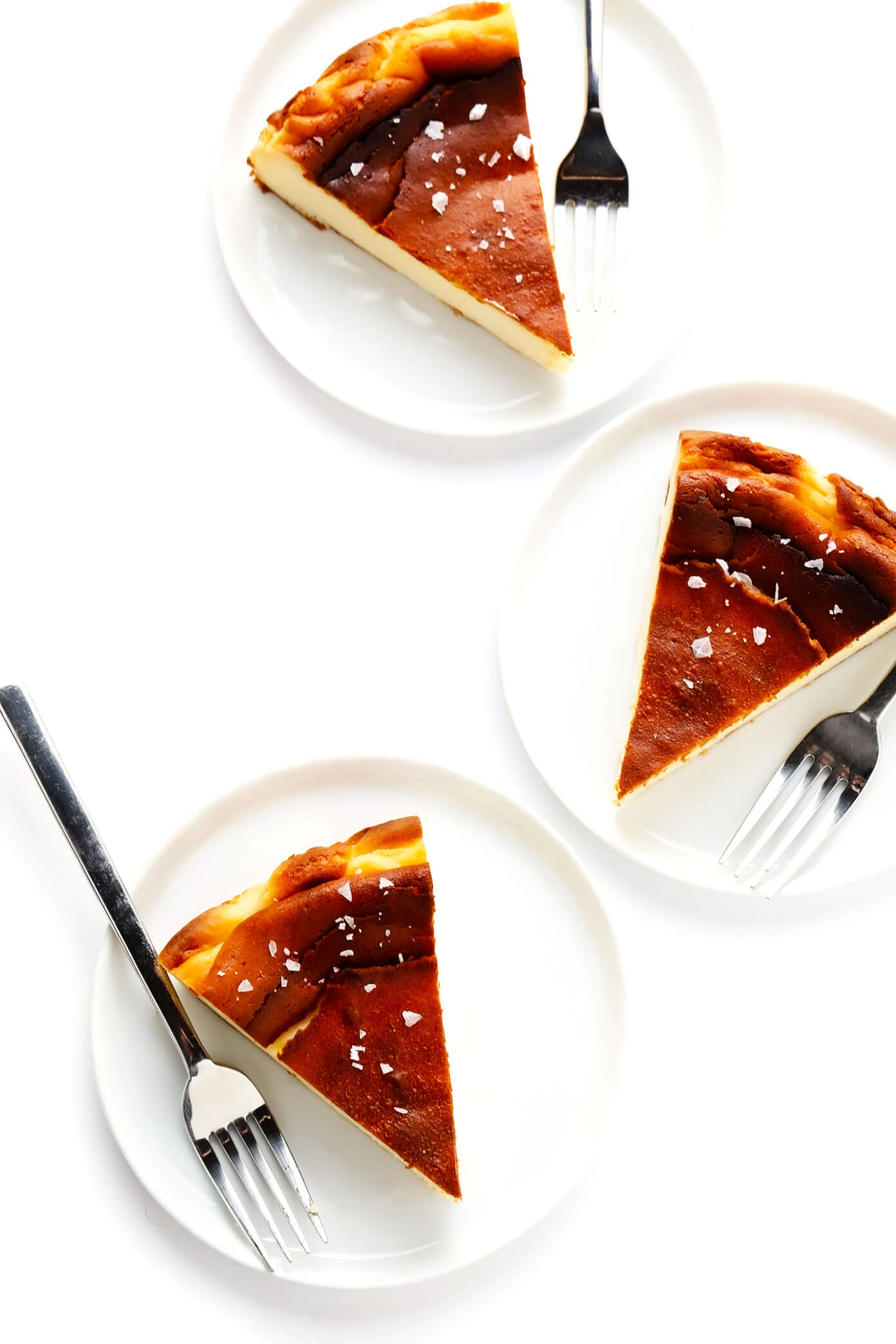 This "Burnt" Basque Cheesecake recipe (known here in Spain as 'tarta de queso') is uniquely light, creamy, delicious, caramelized, and so easy to make that it's nearly foolproof! Such a great dessert recipe for all occasions. | gimmesomeoven.com #basque #cheesecake #spanish #spain #sansebastian #dessert #tartadequeso #caramelized Basque Cheesecake sprinkled with flaky sea salt