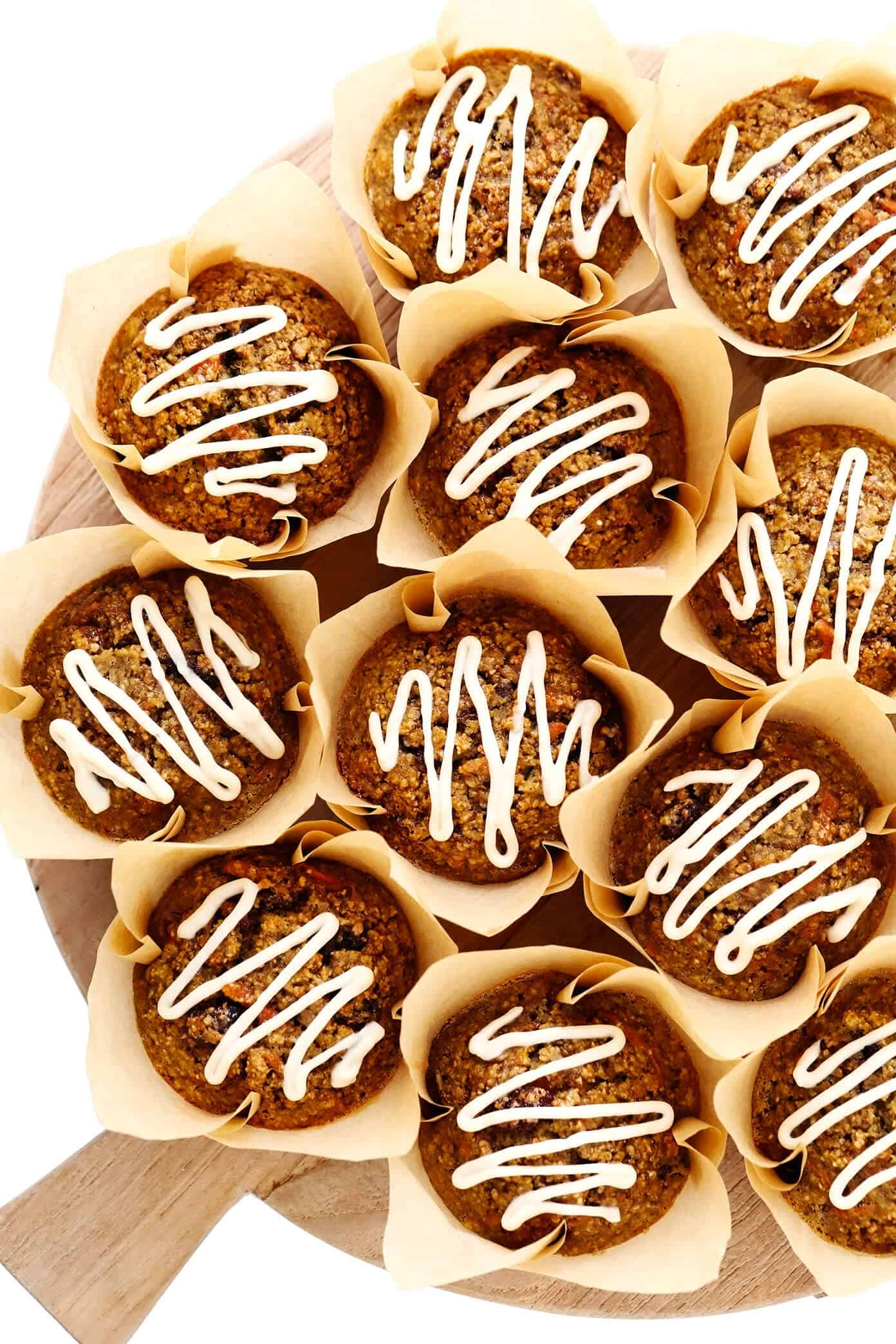 These Healthy Carrot Cake Muffins are easy to make with oatmeal, lots of fresh carrots, maple syrup, and a handful of other simple and healthy ingredients. Feel free to top them with a lightened-up cream cheese frosting drizzle, and add in raisins, nuts and/or coconut if you'd like too. Perfect for a feel-good breakfast, snack or dessert! | gimmesomeoven.com #carrot #cake #muffins #healthy #creamcheese #frosting #icing #breakfast #snack #vegetarian #glutenfree #easter #spring Tray of Healthy Carrot Cake Muffins