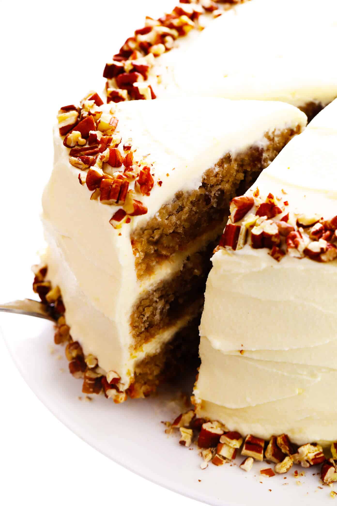 This delicious hummingbird cake recipe features ultra-moist pineapple banana cake layered with rich cream cheese frosting and a sprinkle of toasted pecans. It's the perfect dessert for spring, summer, or Easter and it's always a crowd fave! | gimmesomeoven.com #cake #dessert #hummingbird #jamaican #southern #creamcheese #frosting #icing #banana #pineapple #pecan Hummingbird cake with cream cheese frosting