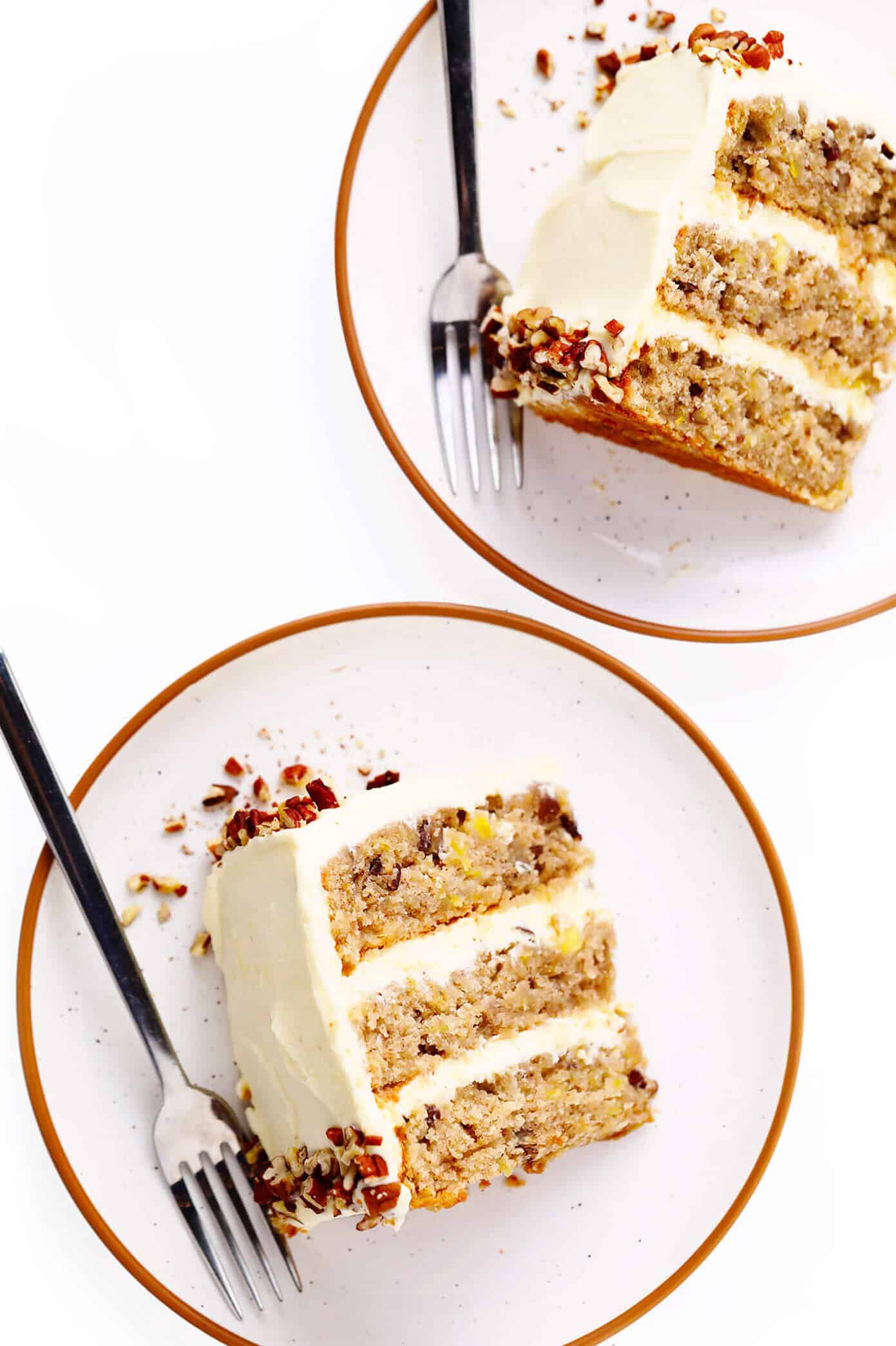 This delicious hummingbird cake recipe features ultra-moist pineapple banana cake layered with rich cream cheese frosting and a sprinkle of toasted pecans. It's the perfect dessert for spring, summer, or Easter and it's always a crowd fave! | gimmesomeoven.com #cake #dessert #hummingbird #jamaican #southern #creamcheese #frosting #icing #banana #pineapple #pecan Slices of hummingbird cake