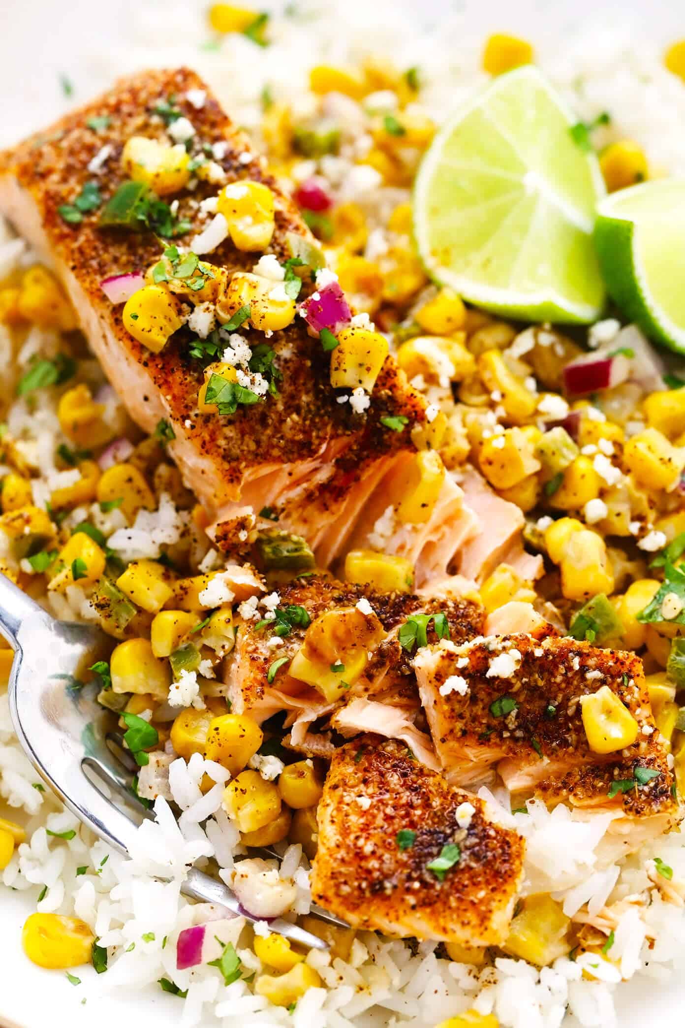 This Chili Lime Salmon recipe (baked or pan-seared) is easy to make and topped with the most delicious esquites (Mexican creamy corn salsa). Served over rice or quinoa, this healthy, gluten-free dinner recipe is full of amazing flavor and ready to go in less than 30 minutes! | gimmesomeoven.com Chili Lime Salmon with Esquites Closeup