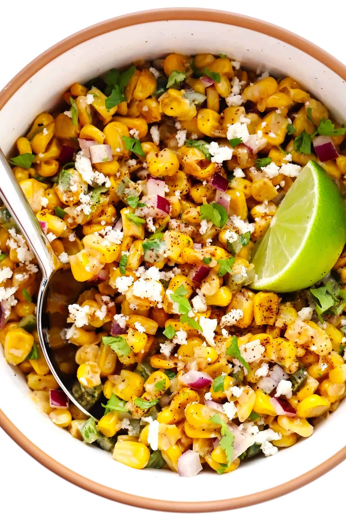 This Chili Lime Salmon recipe (baked or pan-seared) is easy to make and topped with the most delicious esquites (Mexican creamy corn salsa). Served over rice or quinoa, this healthy, gluten-free dinner recipe is full of amazing flavor and ready to go in less than 30 minutes! | gimmesomeoven.com Esquites (Mexican Creamy Corn Salsa Dip) in Bowl