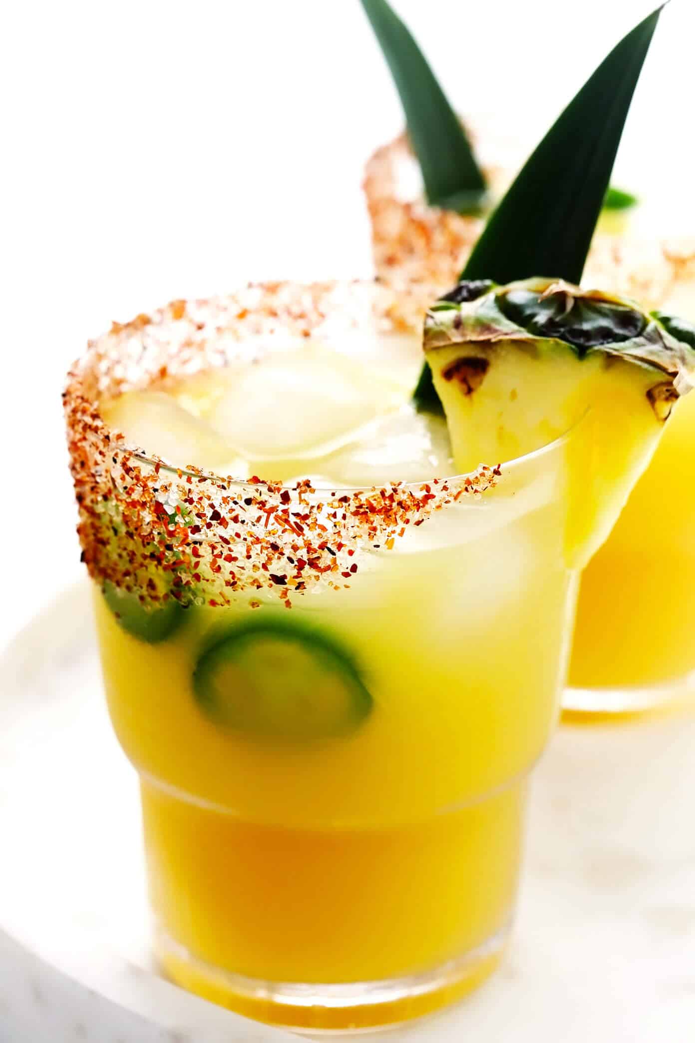 This spicy pineapple margarita recipe is super easy to make and perfectly balanced with sweet, sour, spicy, and smoky (if you opt for mezcal over tequila) flavors. Feel free to add however much or little jalapeño that you prefer to your cocktail! | gimmesomeoven.com Spicy Pineapple Margarita Recipe