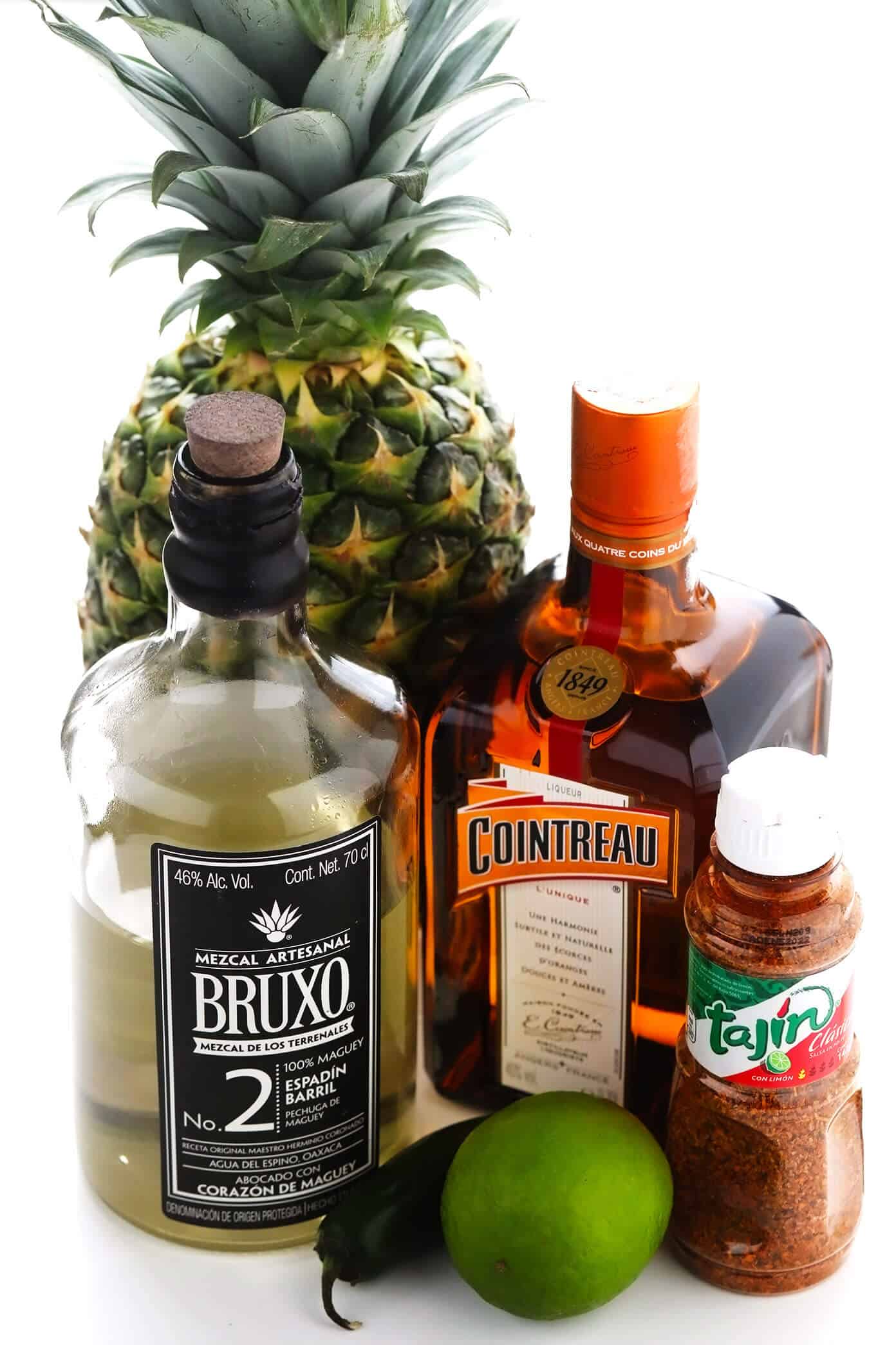 This spicy pineapple margarita recipe is super easy to make and perfectly balanced with sweet, sour, spicy, and smoky (if you opt for mezcal over tequila) flavors. Feel free to add however much or little jalapeño that you prefer to your cocktail! | gimmesomeoven.com Spicy Pineapple Margarita Ingredients -- Pineapple, Mezcal, Cointreau, Lime, Jalapeño and Tajin