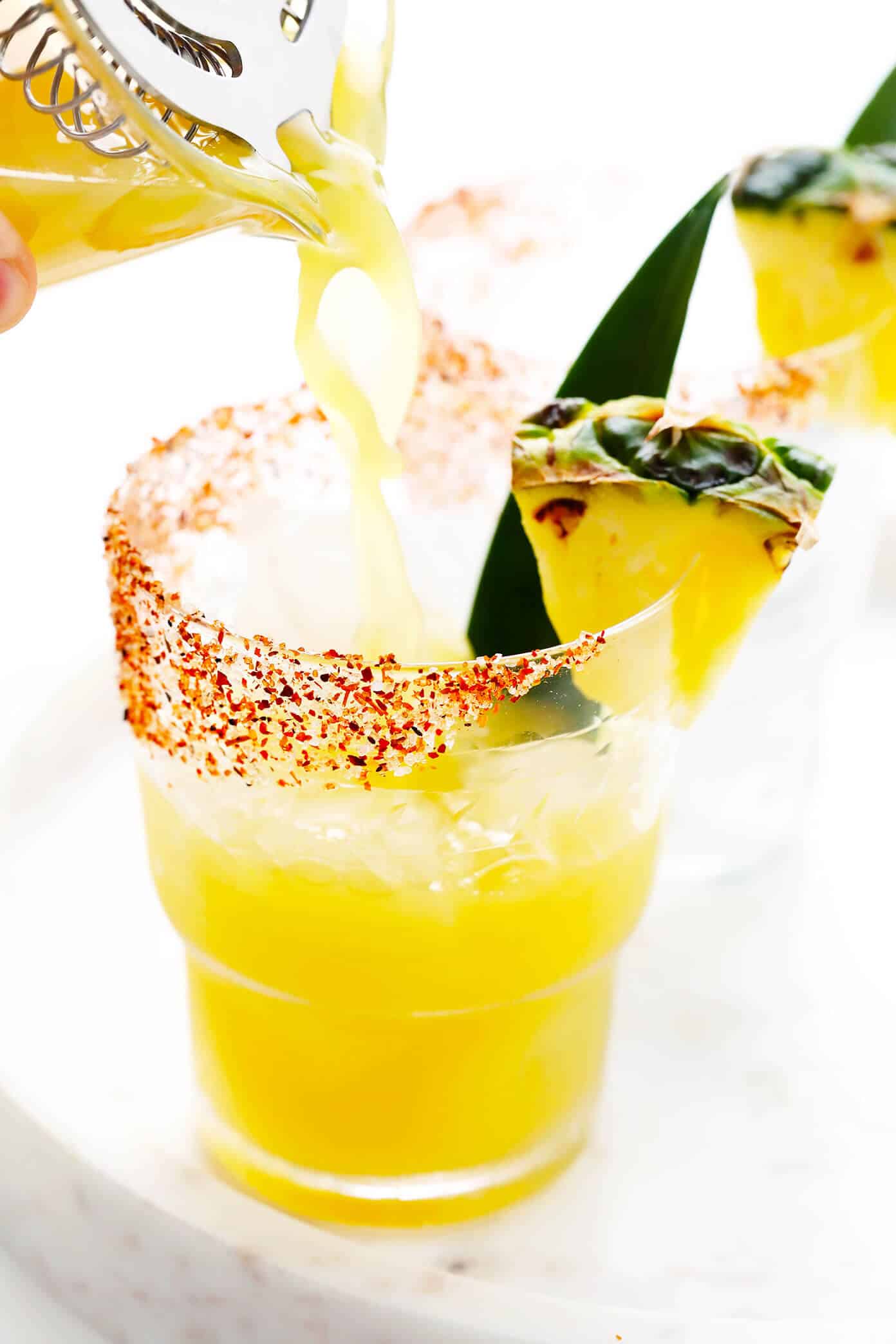 This spicy pineapple margarita recipe is super easy to make and perfectly balanced with sweet, sour, spicy, and smoky (if you opt for mezcal over tequila) flavors. Feel free to add however much or little jalapeño that you prefer to your cocktail! | gimmesomeoven.com How To Make a Pineapple Margarita