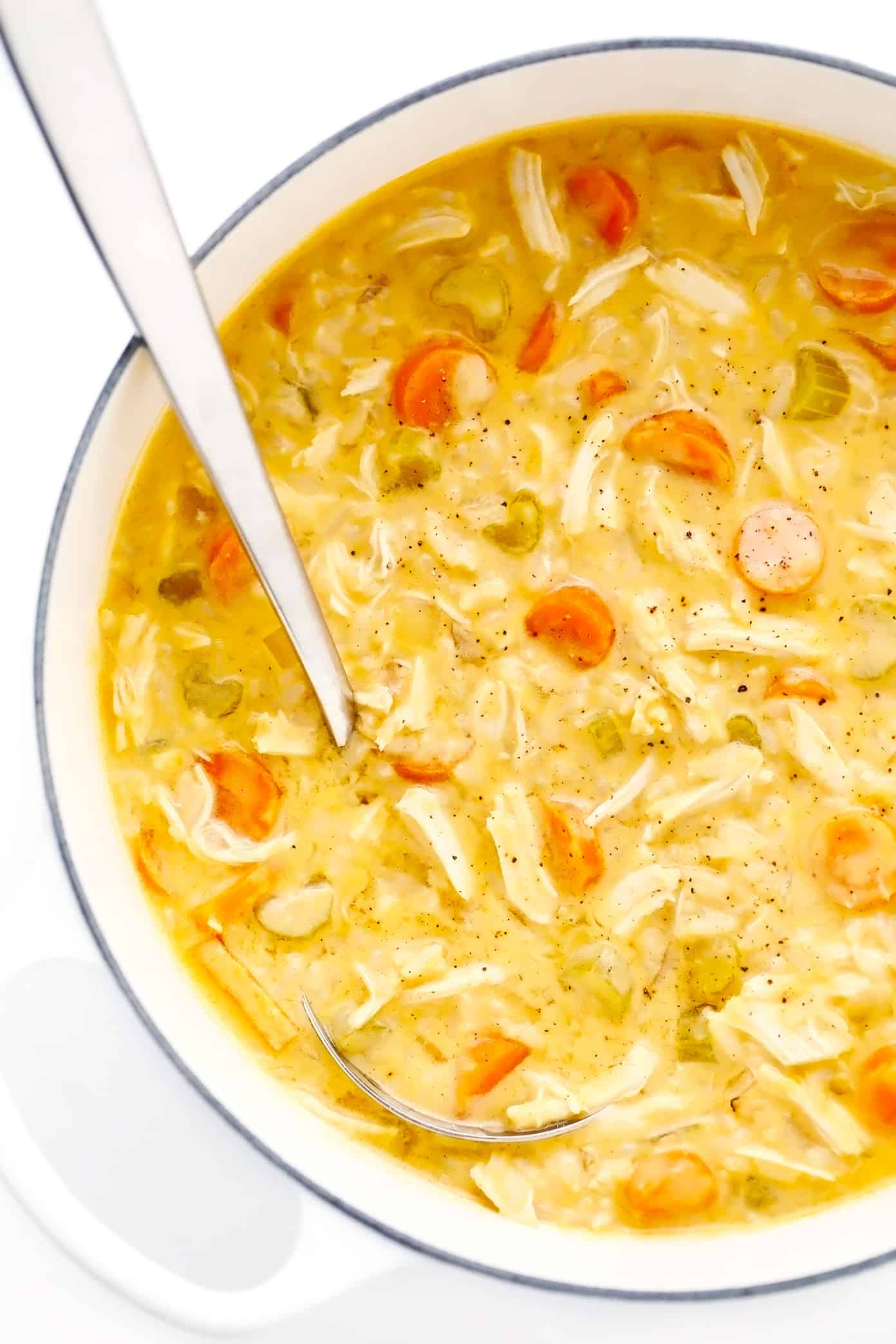 This creamy buffalo chicken and rice soup recipe is simmered with tender chicken, veggies, rice and a zesty blend of buffalo seasonings. Highly recommend topping with blue cheese and bacon too! Perfect for game day or easy weeknight dinner. Stovetop, Instant Pot and Crock-Pot options included. | gimmesomeoven.com Pot of Creamy Buffalo Chicken Soup