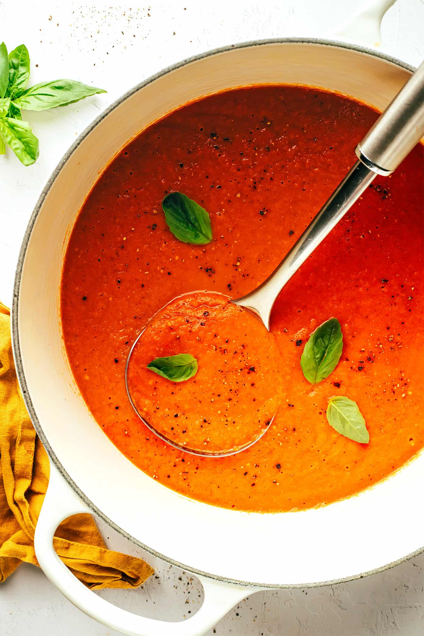 This roasted tomato soup recipe always tastes so fresh and flavorful and it's easy to make with a handful of simple ingredients. Feel free to add cream or croutons if you'd like! | gimmesomeoven.com Roasted Tomato Soup with Basil