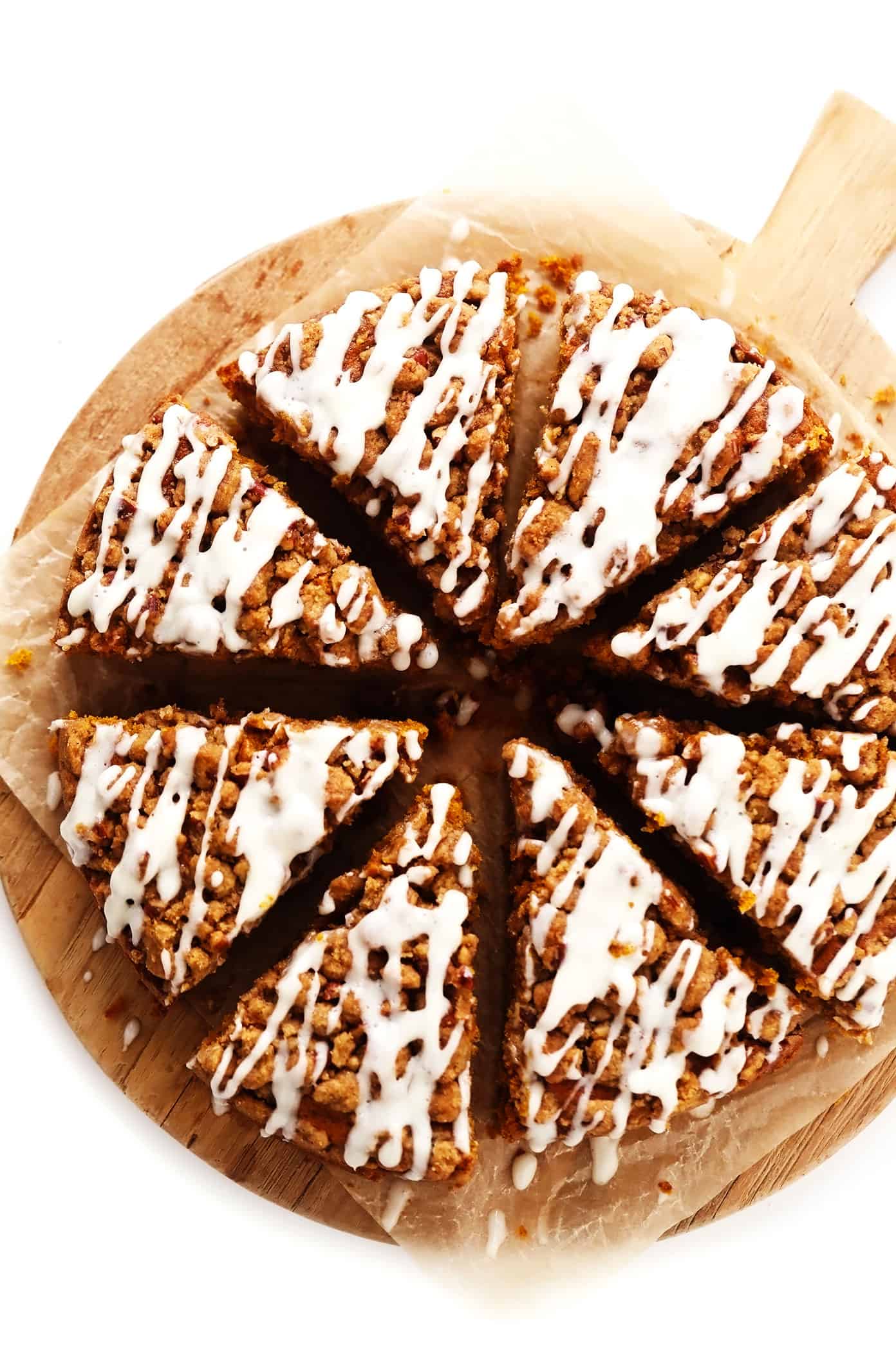 This pumpkin coffee cake is moist and perfectly spiced, then topped with a crunchy streusel crumb topping and a quick cream cheese drizzle. It's easy to make and the perfect breakfast or brunch treat for fall or the holidays! | gimmesomeoven.com Pumpkin Coffee Cake on Serving Platter