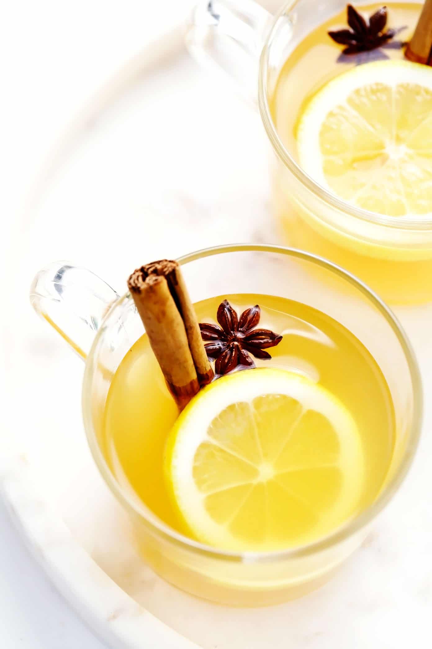 This classic hot toddy recipe is easy to make in just 5 minutes with hot water, whiskey, lemon and honey. Feel free to use your favorite type of whiskey for this cocktail, plus any additional add-ins (I recommend fresh ginger) or garnishes (such as cinnamon, star anise or citrus twists) that you enjoy. You can also omit the alcohol altogether to make this a non-alcoholic drink. | gimmesomeoven.com Hot Toddy with Cinnamon, Lemon and Star Anise Garnish