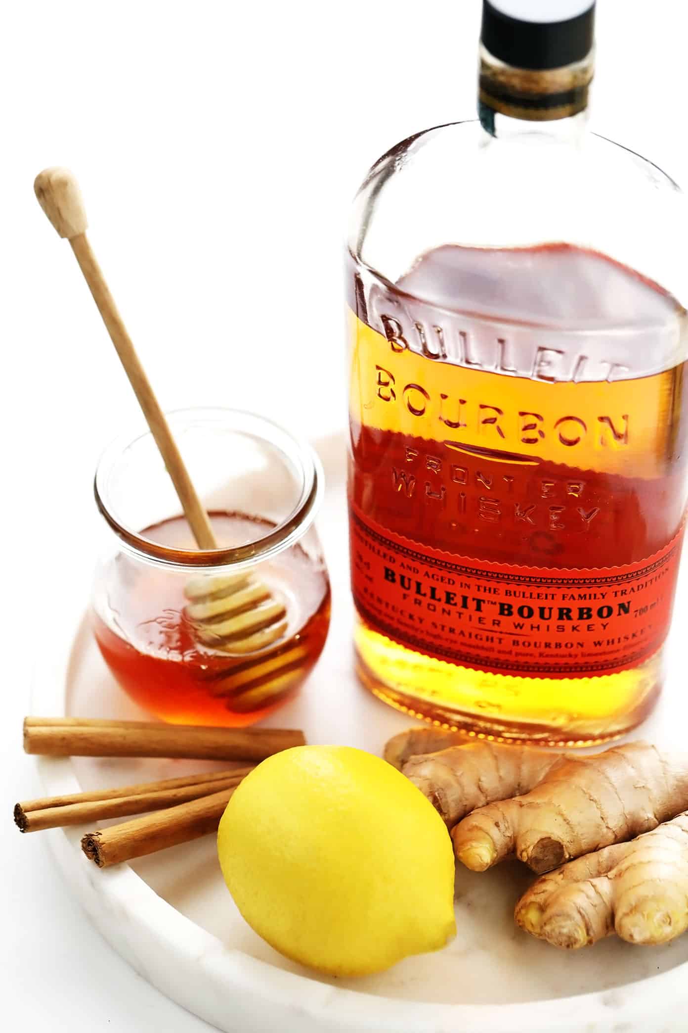 This classic hot toddy recipe is easy to make in just 5 minutes with hot water, whiskey, lemon and honey. Feel free to use your favorite type of whiskey for this cocktail, plus any additional add-ins (I recommend fresh ginger) or garnishes (such as cinnamon, star anise or citrus twists) that you enjoy. You can also omit the alcohol altogether to make this a non-alcoholic drink. | gimmesomeoven.com Hot Toddy Ingredients: bourbon, honey, lemon, cinnamon sticks and ginger