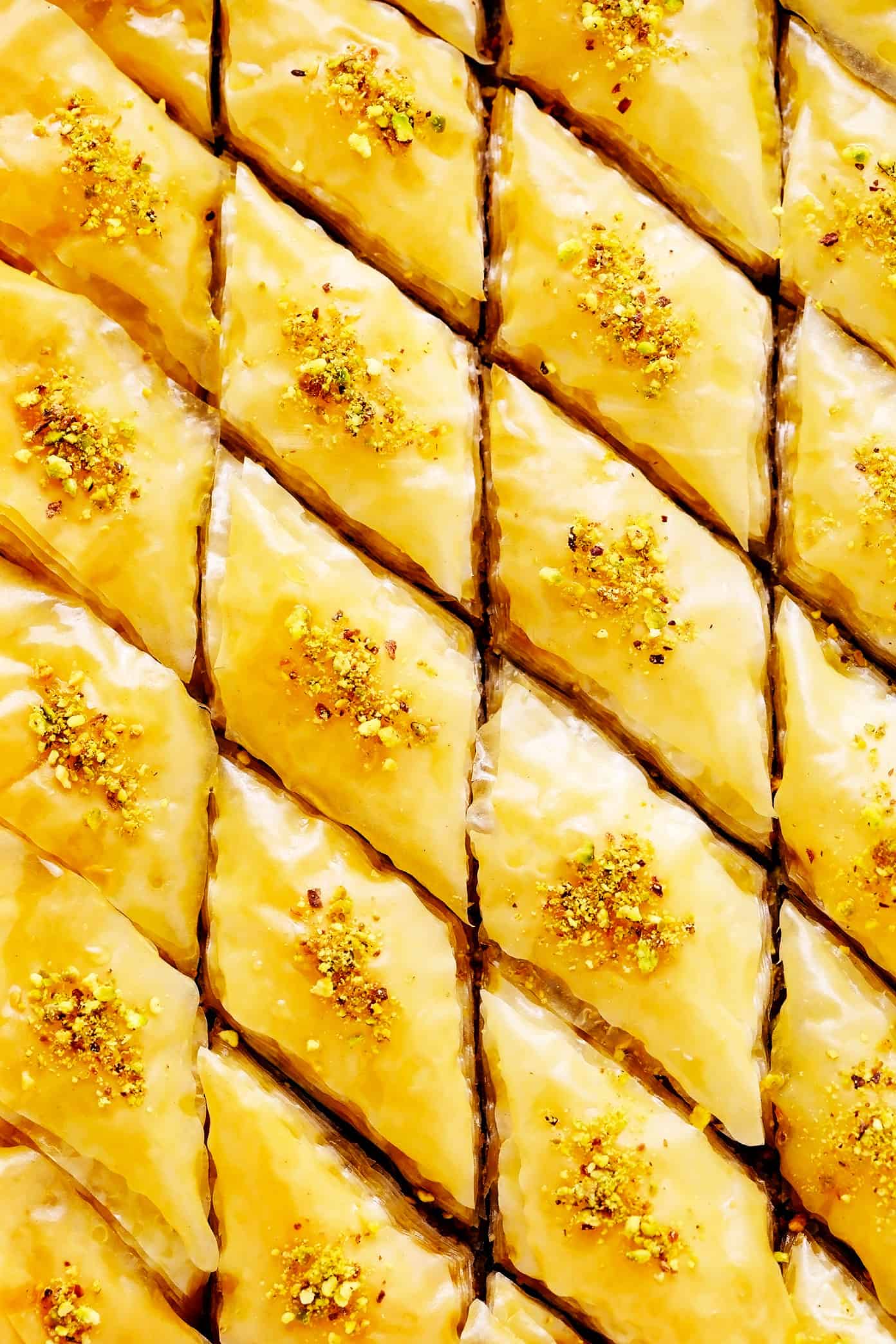 A step-by-step guide (and video) for how to make homemade baklava with perfectly crispy golden layers of buttery phyllo, pistachios and walnuts (or your choice of nuts), and lovely orange honey syrup. Always such a delicious treat! | gimmesomeoven.com Homemade Baklava