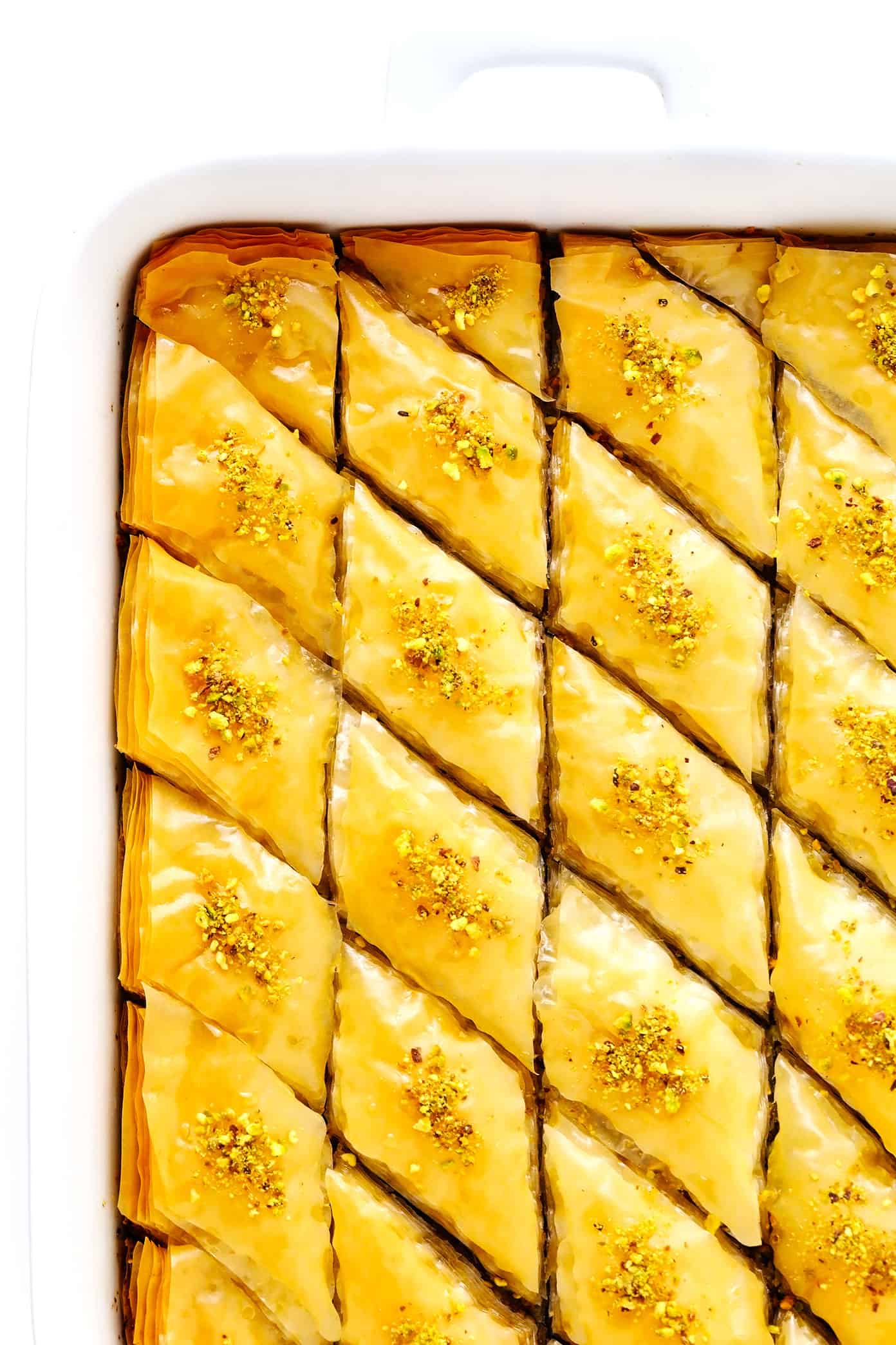 A step-by-step guide (and video) for how to make homemade baklava with perfectly crispy golden layers of buttery phyllo, pistachios and walnuts (or your choice of nuts), and lovely orange honey syrup. Always such a delicious treat! | gimmesomeoven.com Baklava