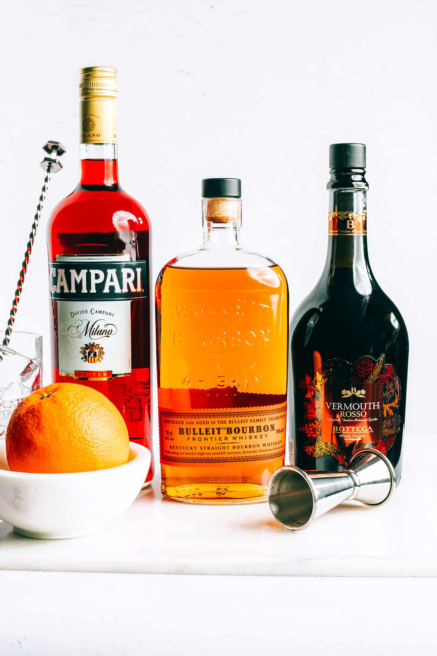 This Boulevardier cocktail recipe is quick and easy to make with Campari, bourbon and sweet vermouth. The perfect quick and easy drink when you're craving something bittersweet! | gimmesomeoven.com Boulevardier Ingredients - Campari, Bourbon, Sweet Vermouth and Orange