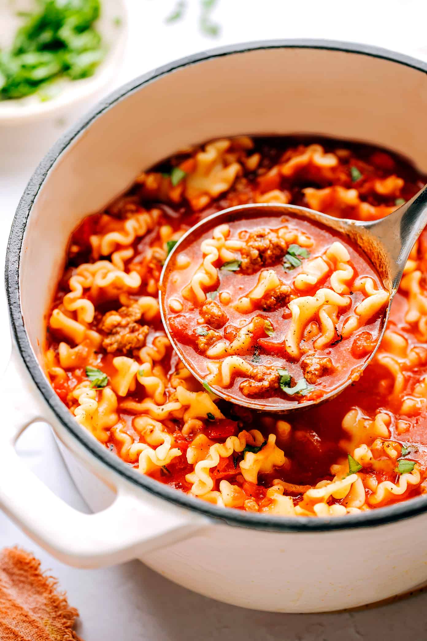 This easy lasagna soup recipe is made with Italian sausage (traditional or plant-based), a garlicky tomato herb broth, your choice of pasta, and three types of cheese (hello, mozzarella, ricotta AND Parmesan). Easy to make vegetarian, vegan and/or gluten-free if you'd like. And always such a cozy Italian 30-minute dinner recipe! | gimmesomeoven.com Lasagna soup in a pot