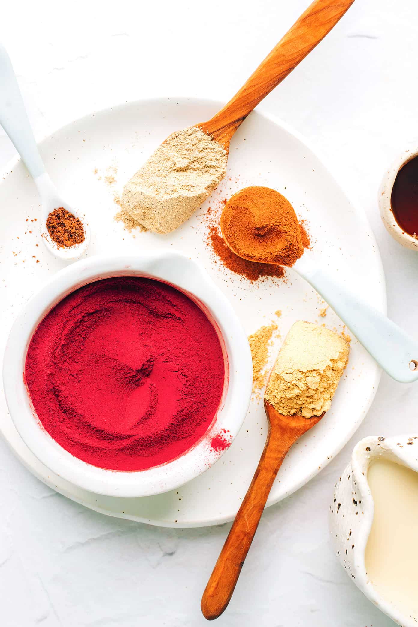 This nutrient-rich pink latte recipe is easy to make hot or iced and features a cozy mix of beetroot powder and warming spices (cardamom, cinnamon, ginger and cloves), your choice of milk and a hint of sweetener. Such cozy, vibrant and delicious drink! | gimmesomeoven.com Pink Latte Ingredients