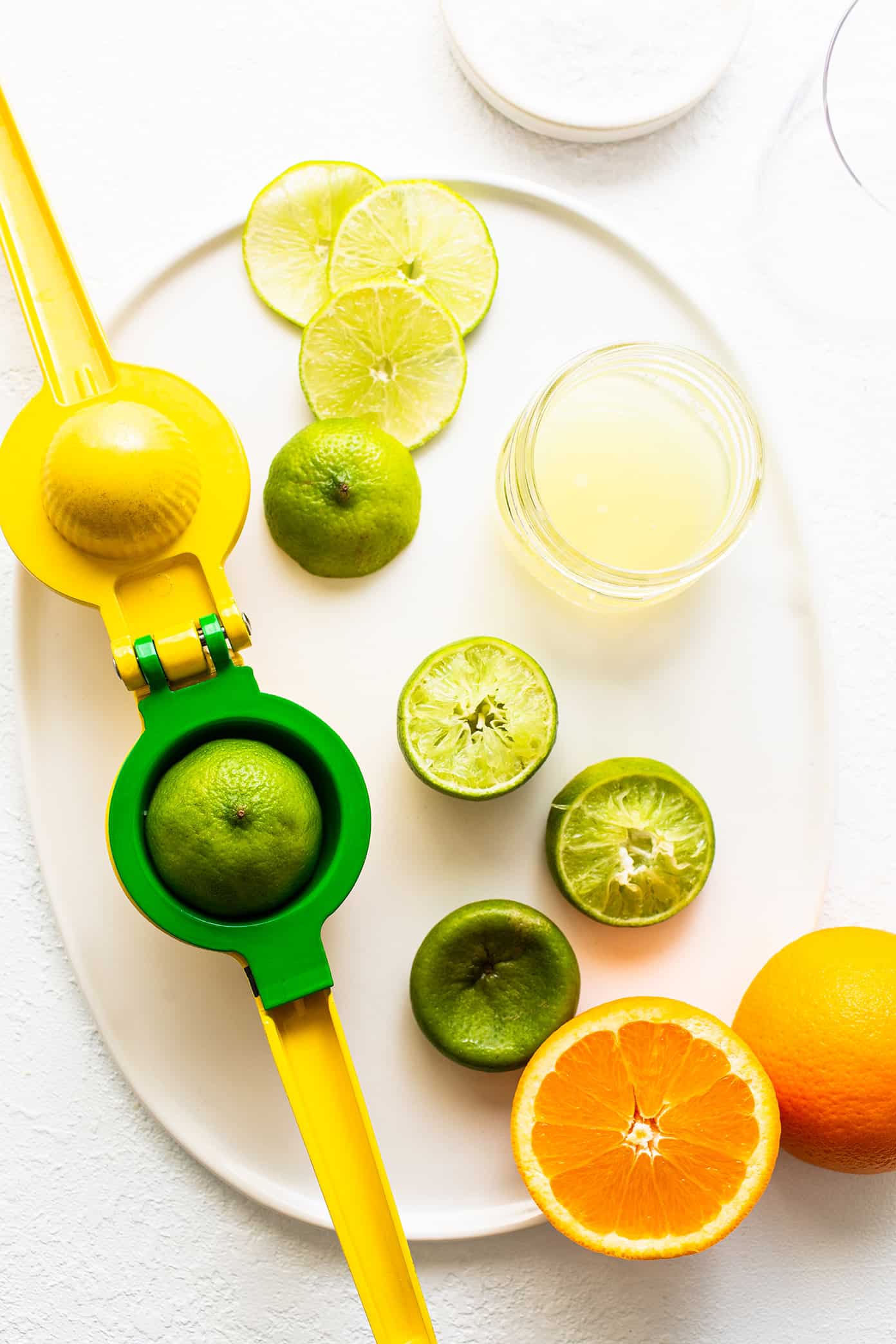 This virgin margarita mocktail recipe is quick and easy to make without alcohol, yet it's still so tangy, refreshing and delicious. Perfect to serve with your favorite Mexican food...or anytime you're craving a great mocktail! | gimmesomeoven.com Virgin Margarita Ingredients on Plate