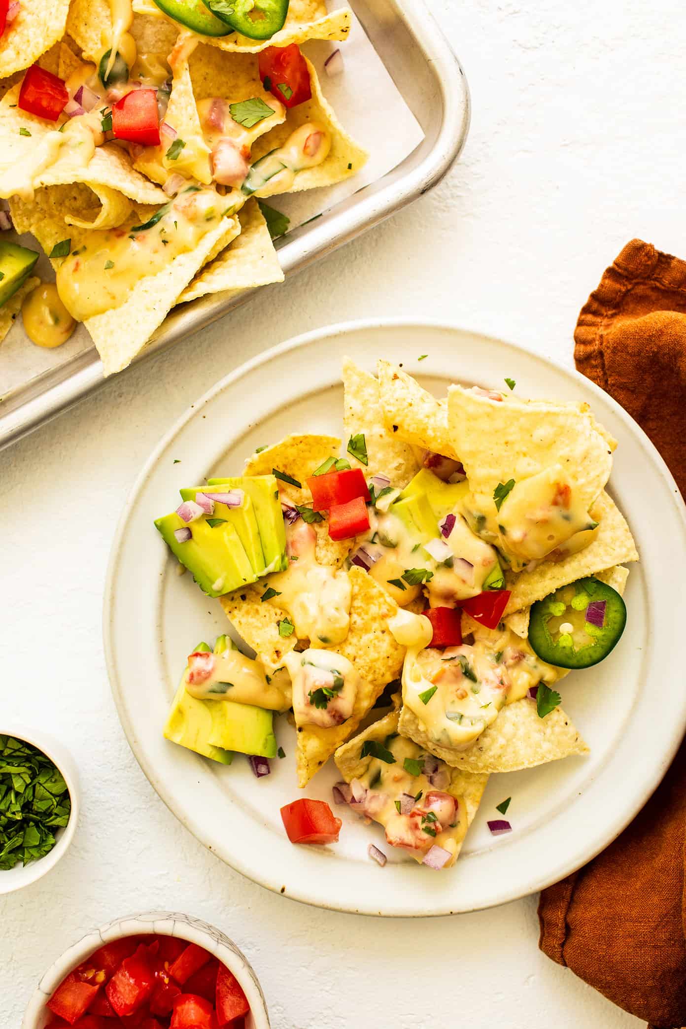 This queso blanco (white cheese dip) recipe is easy to make in about 20 minutes, perfectly melty and scoop-able, and irresistibly delicious. Easy to make with spinach, tomatoes, chiles and the perfect blend of melting cheeses in just 15 minutes, and always everyone's favorite appetizer! | gimmesomeoven.com Nachos with Queso Blanco
