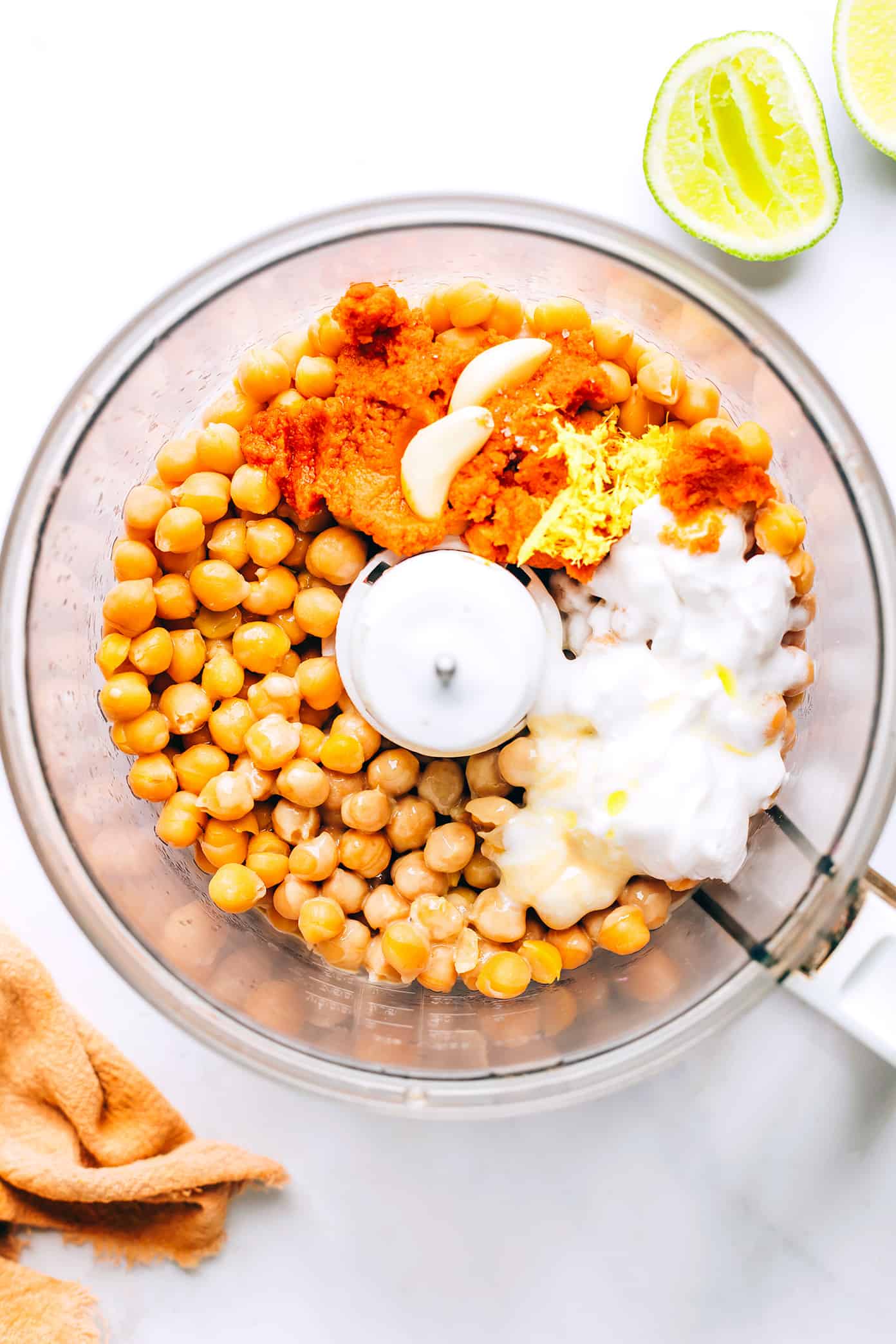 This Thai-inspired red curry hummus recipe is quick and easy to make in just 10 minutes with chickpeas, tahini, coconut milk, curry paste, ginger and garlic. Serve it up as a dip with crudités and naan, or use it as a spread on burgers or wraps. Such a great easy appetizer! | gimmesomeoven.com Red Curry Hummus in Food Processor