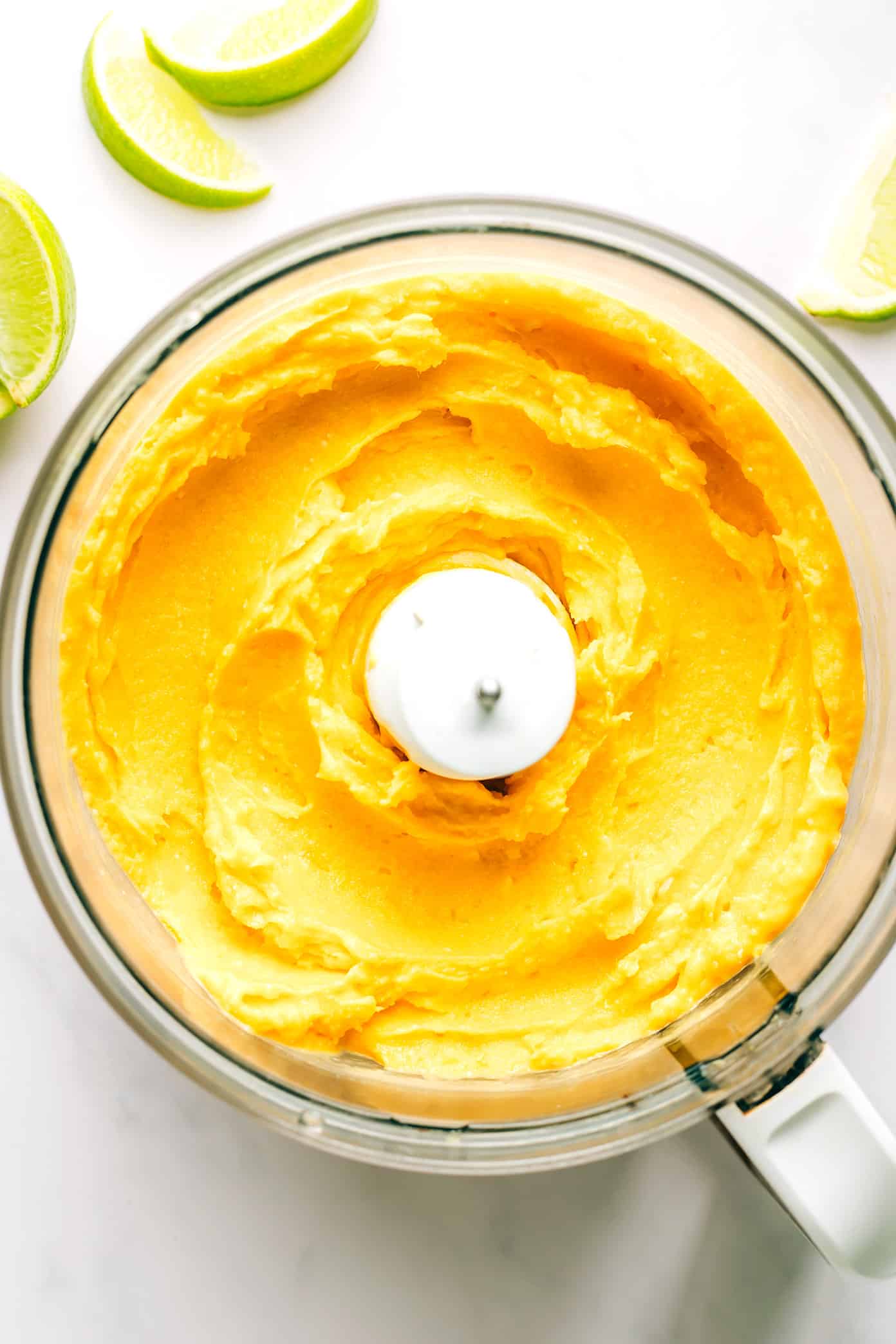 This 5-minute mango lime sorbet is easy to make in a food processor or blender, and made with a delicious blend of mango, lime, coconut milk and fresh ginger. It's the perfect refreshing dessert for summer entertaining, and naturally gluten-free, dairy-free, vegetarian and vegan. | gimmesomeoven.com Mango Lime Sorbet in Food Processor