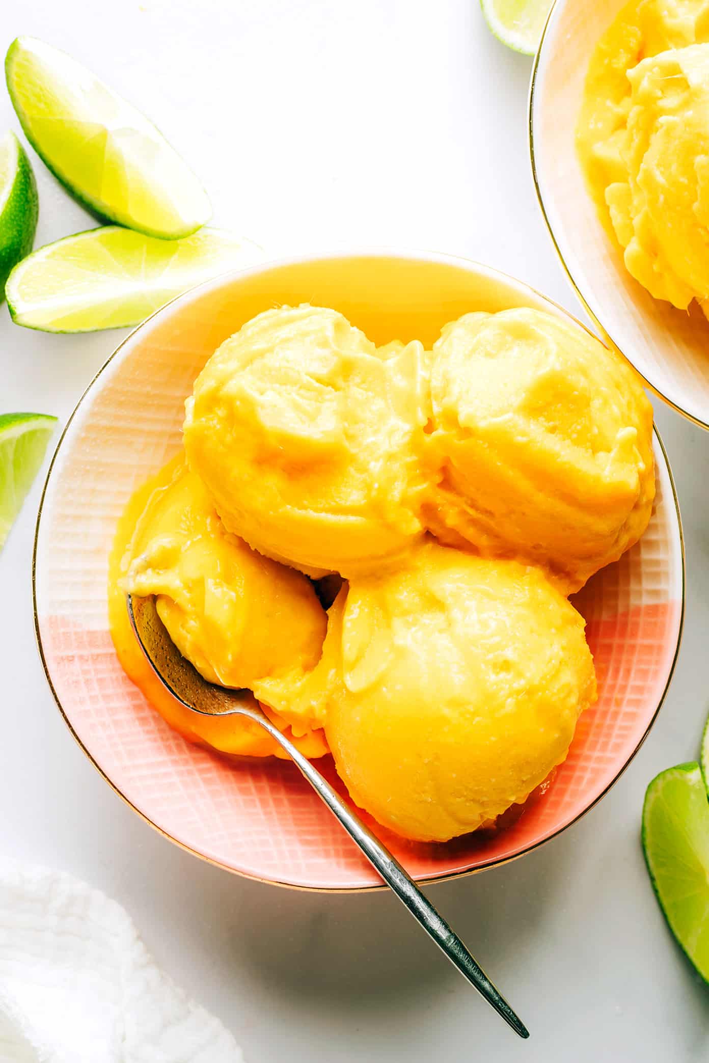 This 5-minute mango lime sorbet is easy to make in a food processor or blender, and made with a delicious blend of mango, lime, coconut milk and fresh ginger. It's the perfect refreshing dessert for summer entertaining, and naturally gluten-free, dairy-free, vegetarian and vegan. | gimmesomeoven.com Mango Lime Sorbet