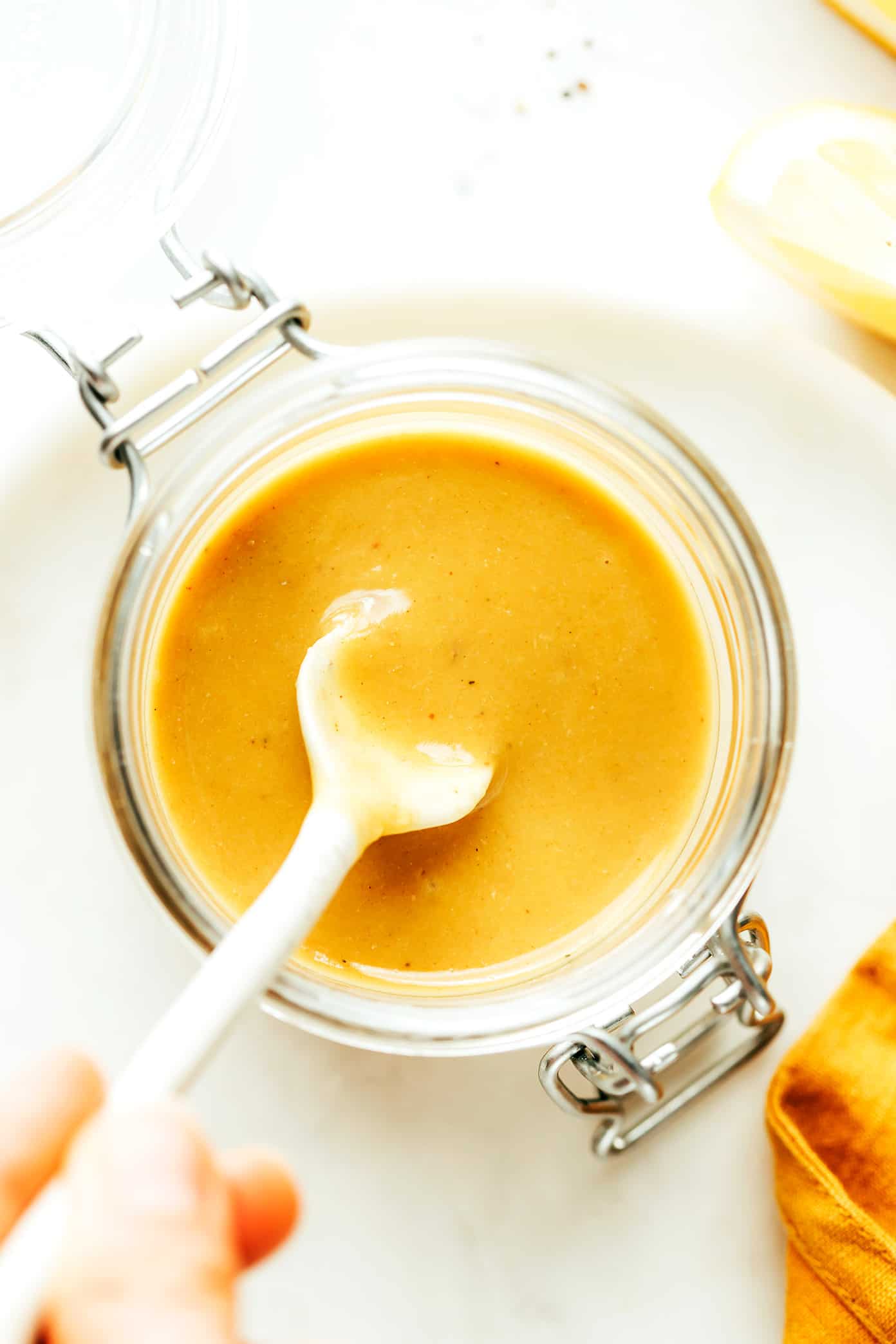 This "caesar-ish" dressing (anchovy vinaigrette) recipe is quick and easy to make with just 5 simple ingredients, and it's full of the most delicious, bold, savory, umami flavors. Perfect for tossing with salads, pasta, vegetables, seafood, meat, burgers, or whatever else sounds good! | gimmesomeoven.com Caesar-ish dressing (anchovy vinaigrette) in jar