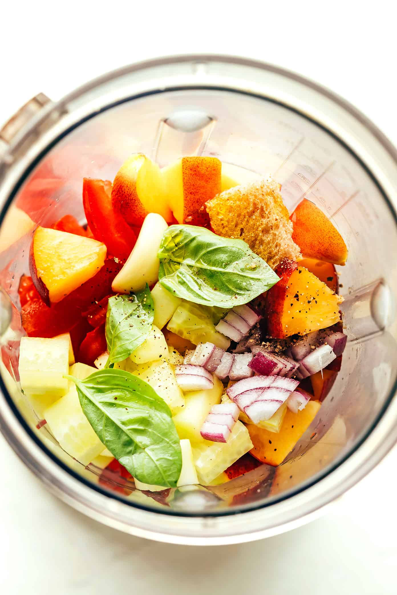 This fresh peach tomato gazpacho recipe features a delicious blend of sweet and savory flavors and comes together easily in just 10 minutes. It's the perfect cold soup for hot summer days, and always so delicious and refreshing! | gimmesomeoven.com Peach Gazpacho Ingredients in Blender