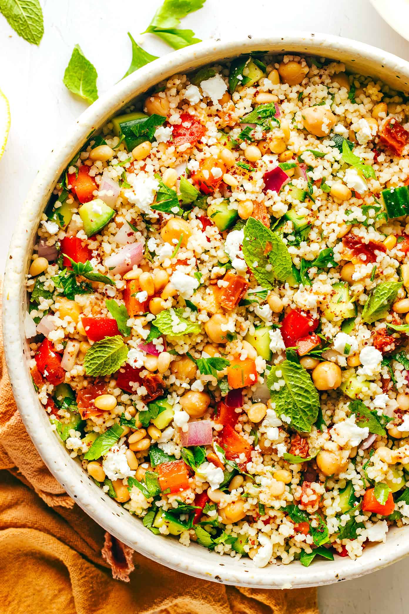 This simple couscous salad is made with loads of fresh veggies (cucumber, bell pepper, red onion), chickpeas, fresh mint and parsley, feta cheese, toasted pine nuts, and a zesty lemon dressing. Feel free to add in some chicken, salmon or shrimp in there too if you'd like. It's the perfect vegetarian entree or side salad...and tastes great for leftovers the next day! | gimmesomeoven.com Couscous Salad