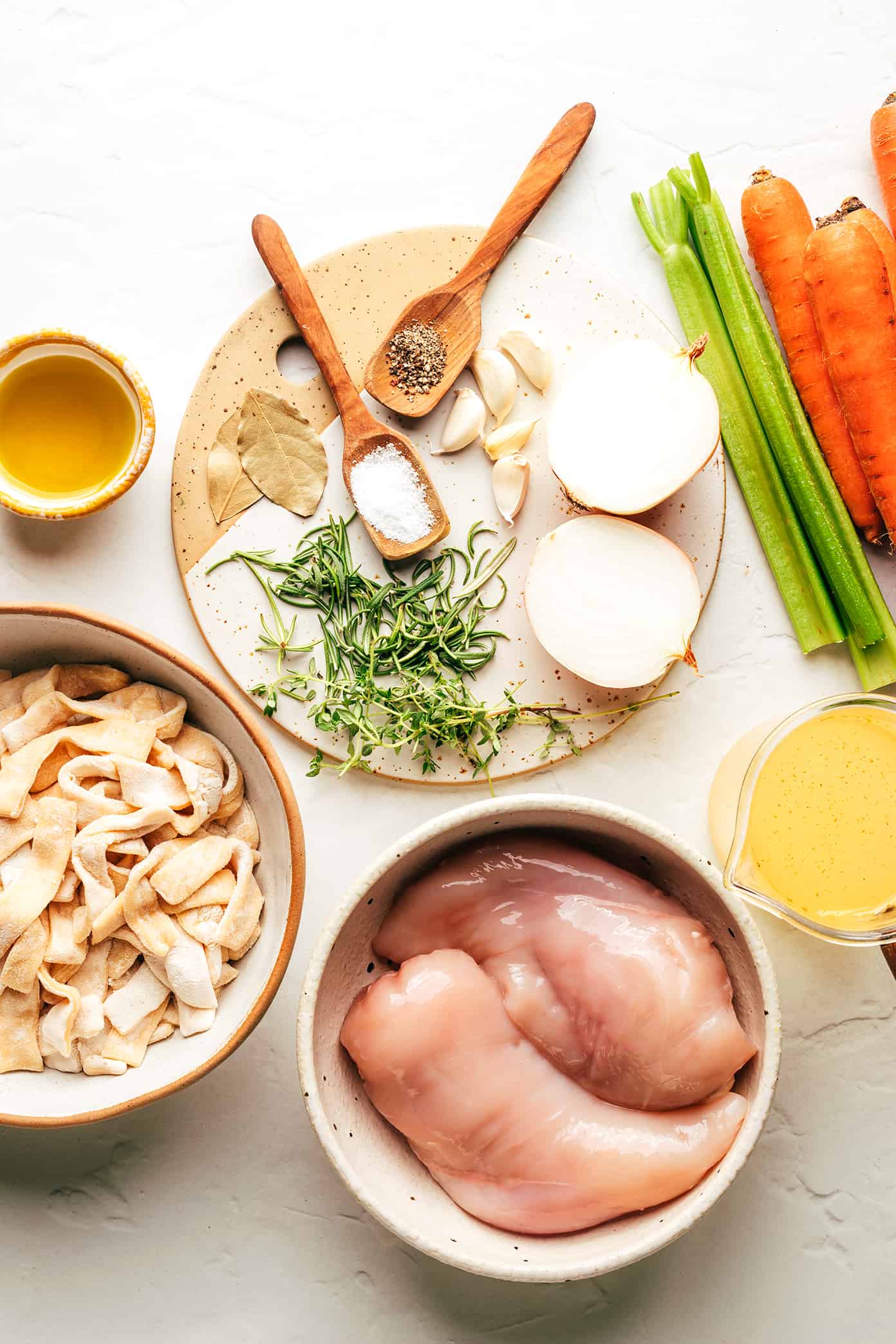 This homemade chicken noodle soup recipe is made with homestyle egg noodles, tender chicken, thick-cut veggies, and the coziest garlic-herb broth. The perfect comfort food to warm you right up! | gimmesomeoven.com Chicken Noodle Soup Ingredients