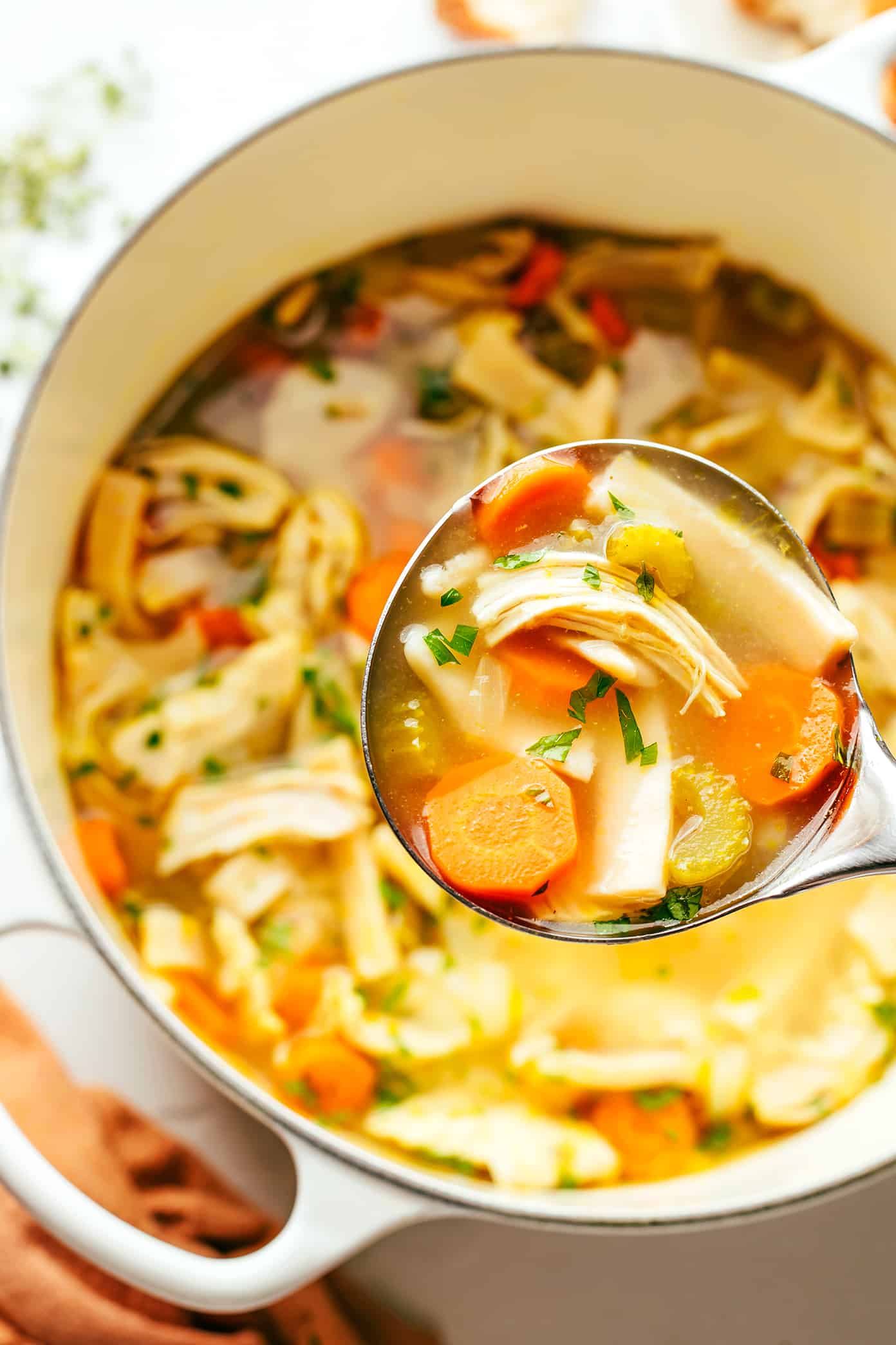 This homemade chicken noodle soup recipe is made with homestyle egg noodles, tender chicken, thick-cut veggies, and the coziest garlic-herb broth. The perfect comfort food to warm you right up! | gimmesomeoven.com Homemade Chicken Noodle Soup in Pot
