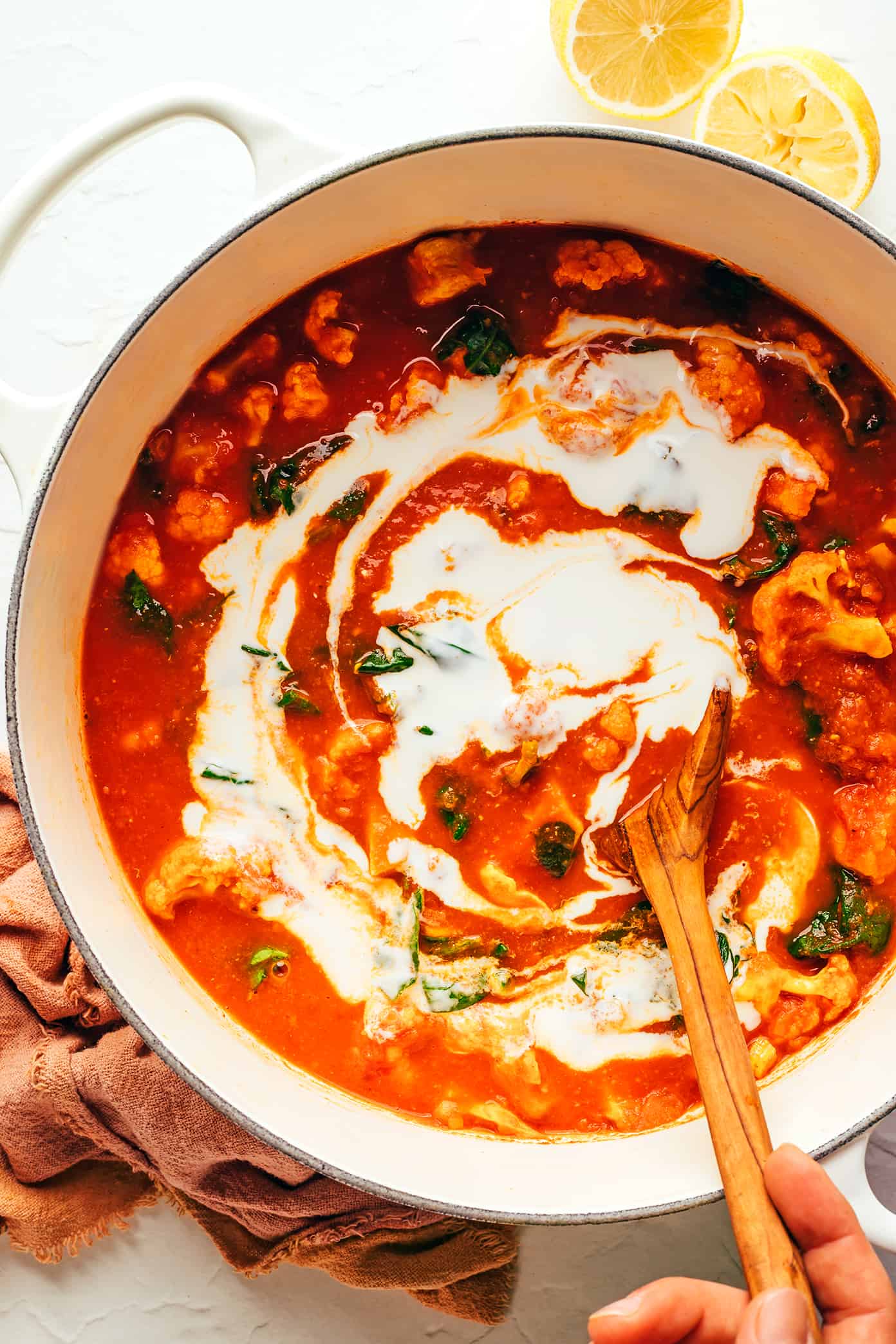 This Indian-inspired butter chicken and cauliflower recipe is easy to make, naturally gluten-free, and simmered with the most delicious curry sauce. Serve with rice or naan and enjoy! | gimmesomeoven.com Stirring Coconut Milk Into Butter Chicken and Cauliflower