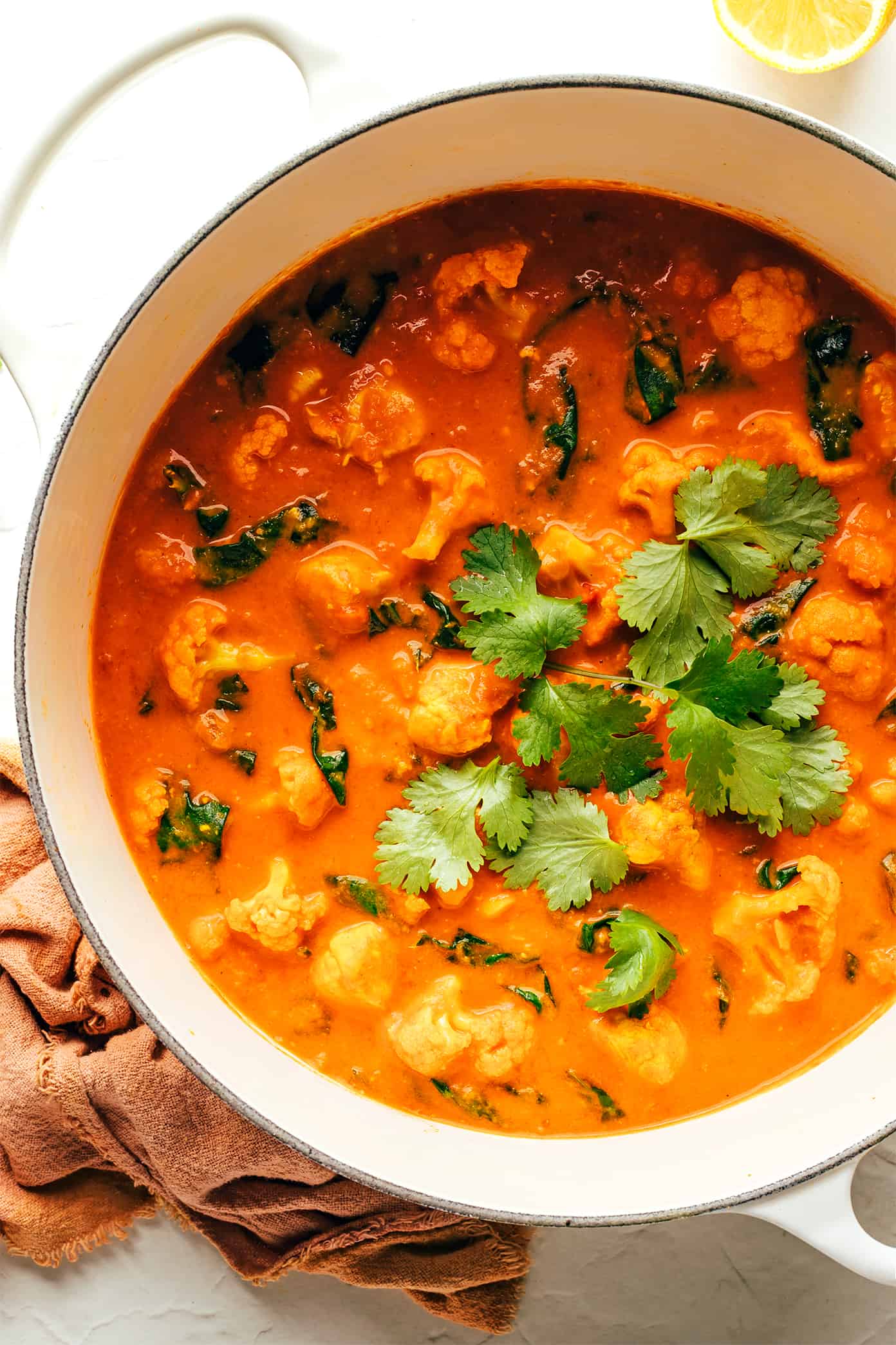 This Indian-inspired butter chicken and cauliflower recipe is easy to make, naturally gluten-free, and simmered with the most delicious curry sauce. Serve with rice or naan and enjoy! | gimmesomeoven.com Butter Chicken and Cauliflower in Pot with Cilantro