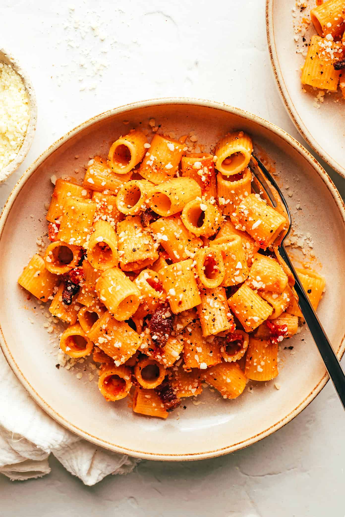 This classic Italian Pasta all'Amatriciana recipe is easy to make with 6 traditional ingredients (guanciale, Pecorino Romano, white wine, tomatoes, chili pepper, and pasta) and full of the best rich and savory flavors. Feel free to make the pasta with spaghetti, bucatini, rigatoni or whatever pasta shape you love best. | gimmesomeoven.com Pasta Amatriciana in Serving Bowl