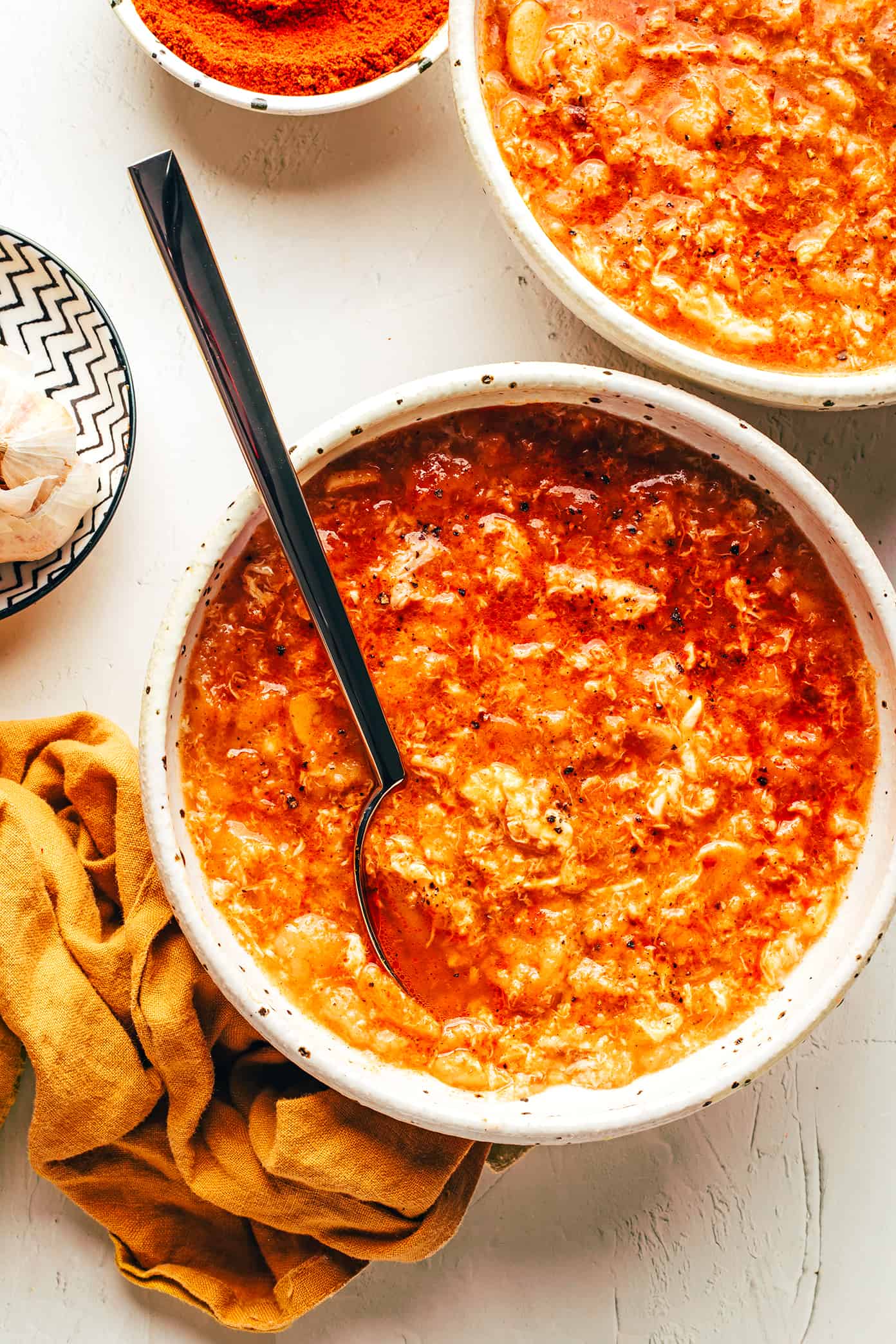 Spanish sopa de ajo (garlic soup or sopa castellana) is incredibly easy to make with just garlic, bread, eggs, broth, olive oil, and smoked paprika. It's a simple vegetarian dinner recipe that comes together in less than 30 minutes and always tastes so flavorful and comforting. | gimmesomeoven.com Sopa de Ajo (Sopa Castellana) in Bowls