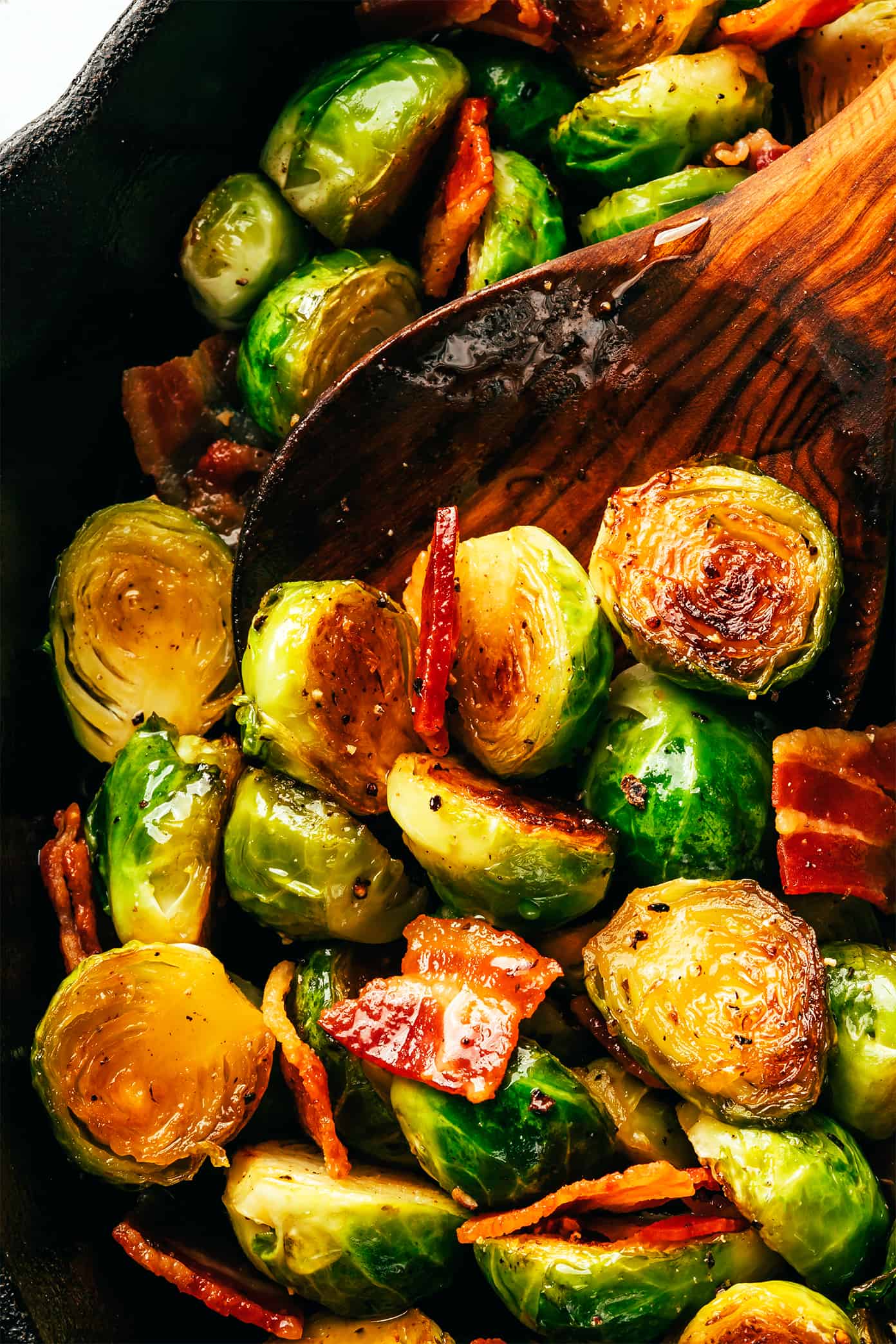 These bacon Brussels sprouts are easy to make and tossed with an irresistible drizzle of hot honey. The perfect side dish for Thanksgiving, dinner parties, or anytime you're just craving some extra-delicious vegetables. | gimmesomeoven.com Bacon Brussels Sprouts Closeup
