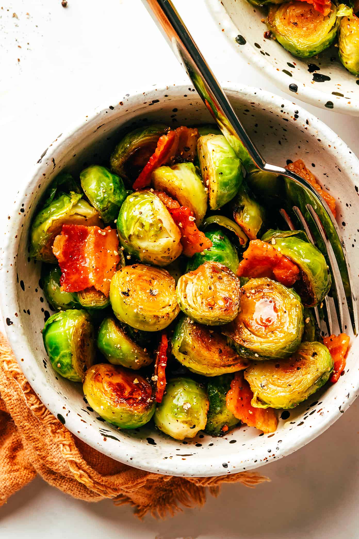 These bacon Brussels sprouts are easy to make and tossed with an irresistible drizzle of hot honey. The perfect side dish for Thanksgiving, dinner parties, or anytime you're just craving some extra-delicious vegetables. | gimmesomeoven.com Bacon Brussels Sprouts with Hot Honey in Bowl