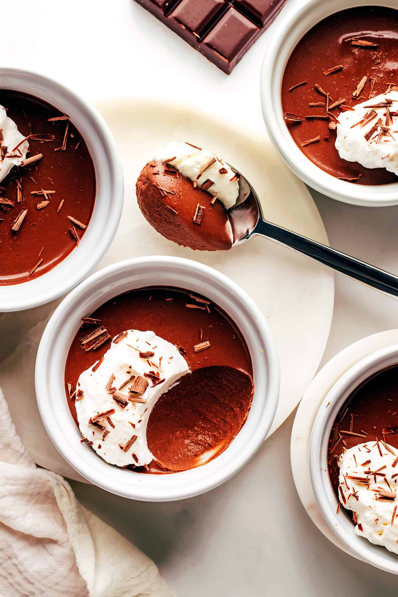 This no-bake chocolate pots de crème recipe comes together with just 20 minutes of active prep time and features a silky-smooth chocolate custard topped with amaretto whipped cream. Naturally gluten-free and the perfect make-ahead dessert for easy entertaining! | gimmesomeoven.com Easy Chocolate Pots de Crème