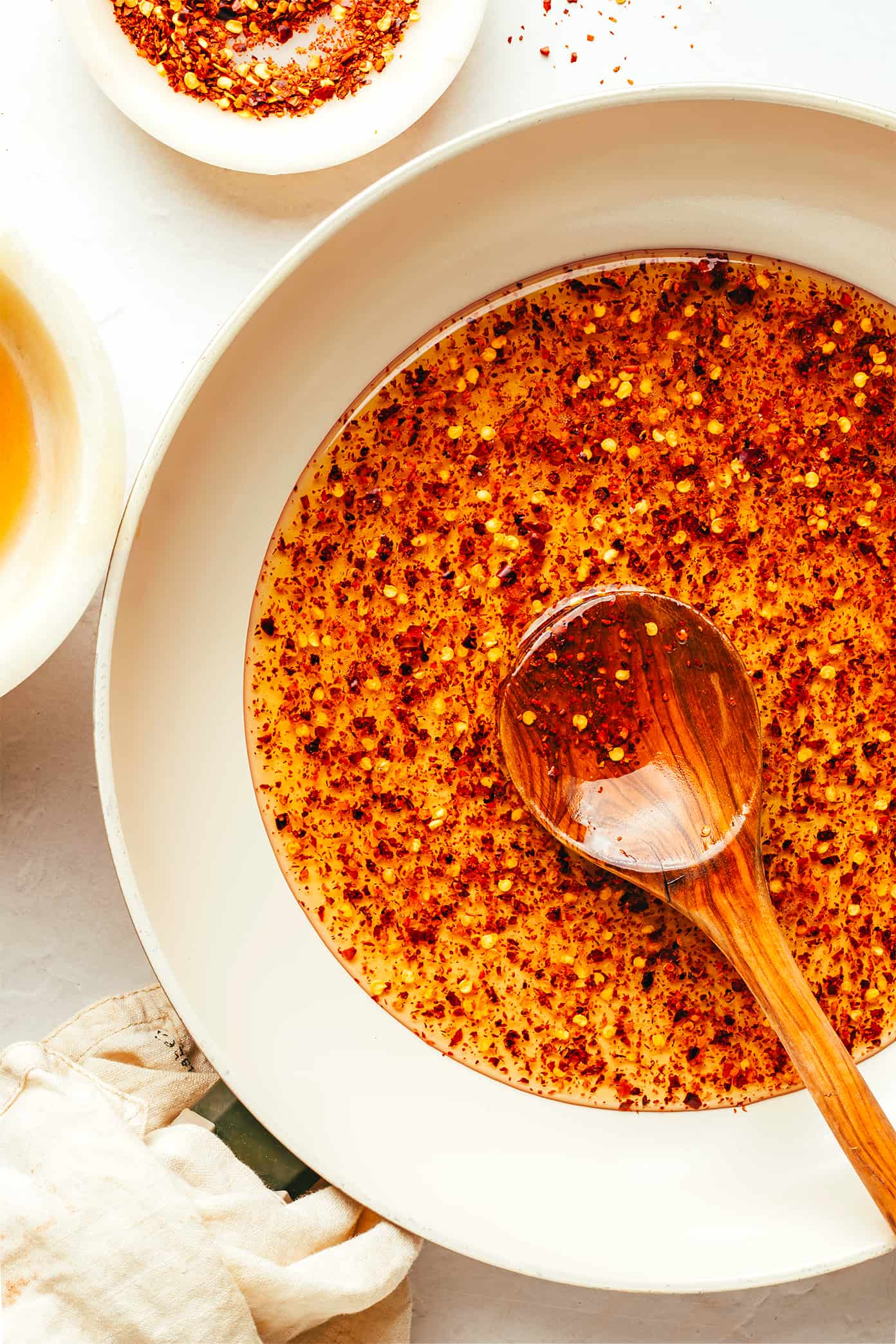 This homemade hot honey recipe is quick and easy to make with 3 ingredients and tastes delicious drizzled on everything from pizza to biscuits, fried chicken, salmon, veggies, baked brie and more! | gimmesomeoven.com Making homemade hot honey recipe in saute pan