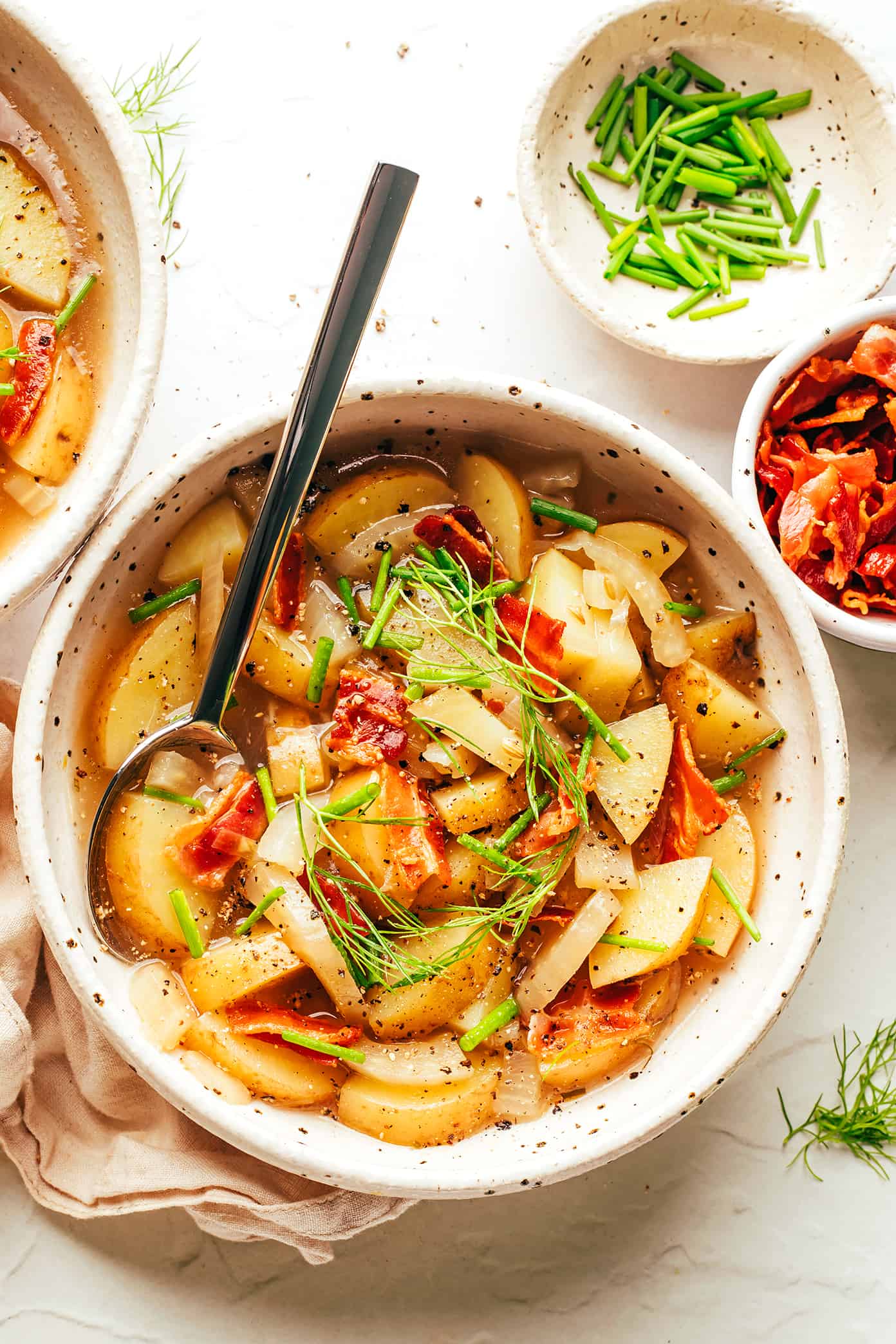 This potato bacon fennel soup recipe is incredibly easy to make and simmered in a garlic-rosemary broth. Easy to make, naturally gluten-free, and always such a cozy and delicious dinner recipe! | gimmesomeoven.com Potato Bacon Fennel Soup in Bowl