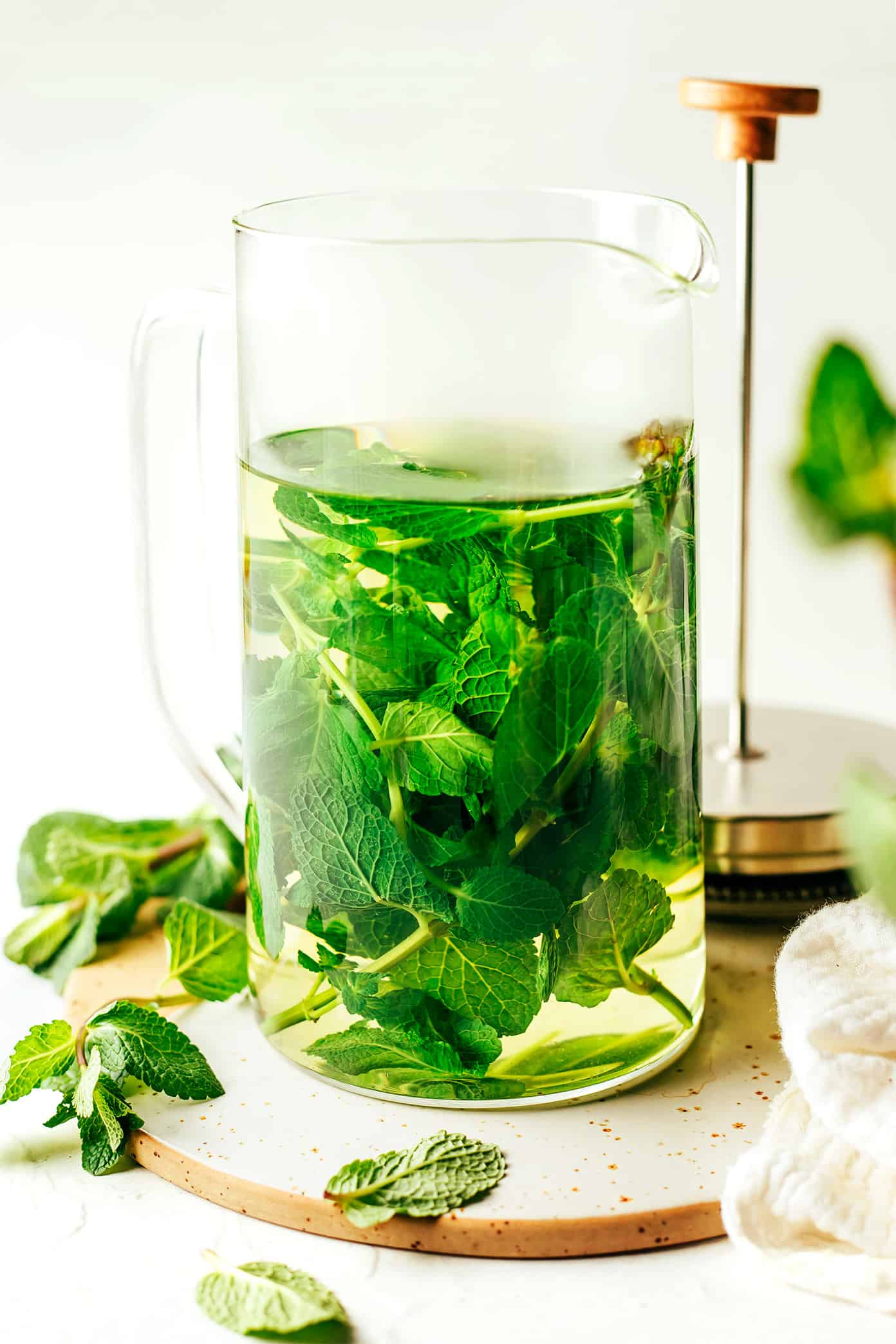 Fresh mint tea is easy to make hot or iced and always tastes so refreshing. Feel free to add sweetener and citrus (lemon or lime) too if you'd like. | gimmesomeoven.com French Press brewing fresh mint tea