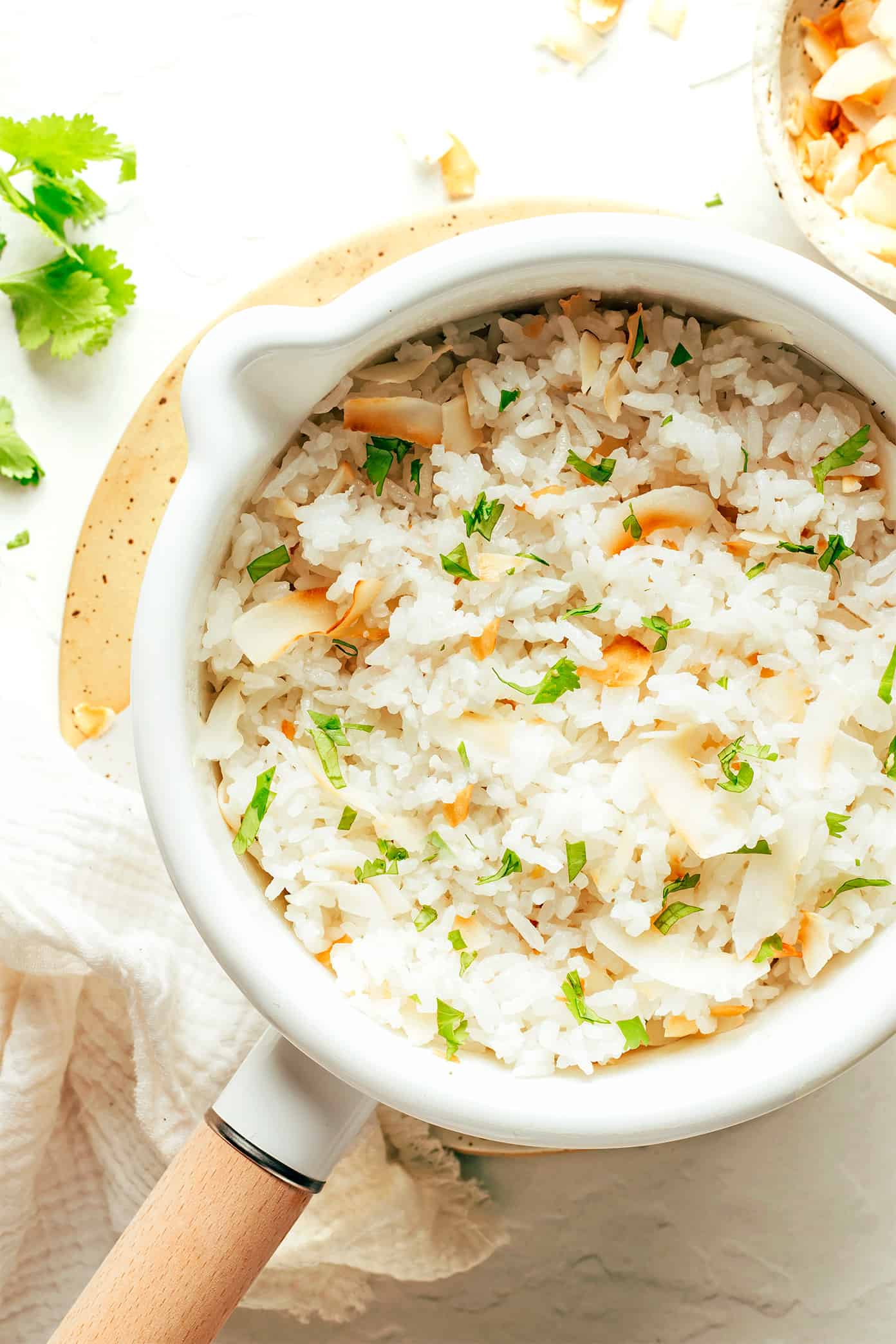 This coconut rice recipe is super easy to make in about 30 minutes and perfectly fluffy with a lightly-sweet coconut flavor. Naturally gluten-free, vegetarian, vegan, and perfect for serving with a savory stir-fry, curry, stew, beans, grilled proteins, roasted vegetables and more. | gimmesomeoven.com Coconut Rice in Saucepan