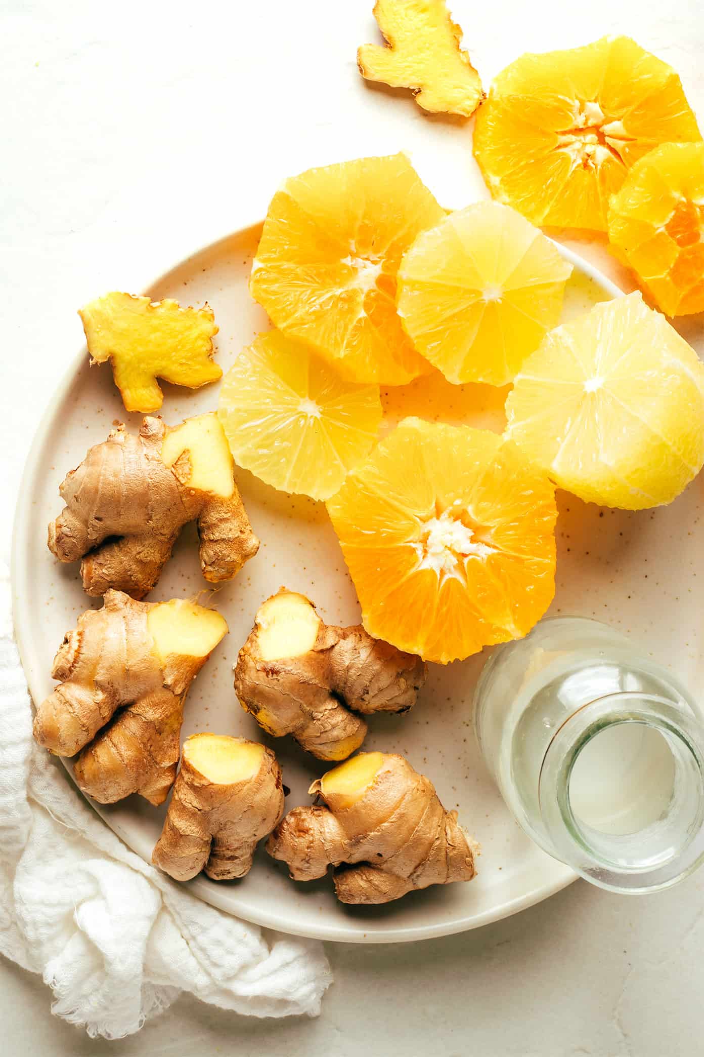 My favorite ginger shot recipe is super easy to make in the blender with 4 ingredients - lemon, orange, coconut water and fresh ginger. Full of healthy anti-inflammatory nutrients, more affordable than the store-bought versions, and easy to customize the flavors to your liking! | gimmesomeoven.com Ginger Shot Ingredients